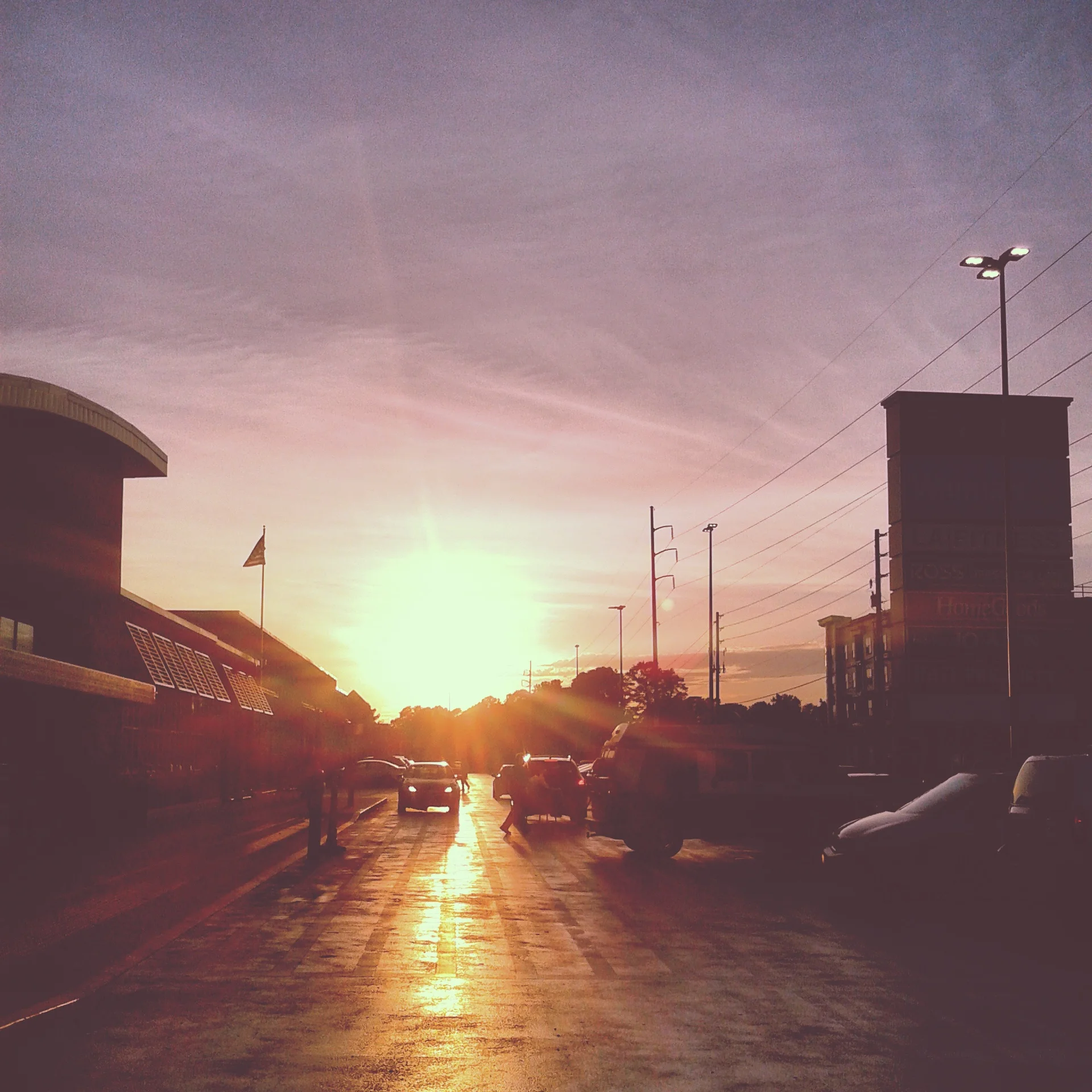 "sun sets on a freshly tarred wal-mart parking lot". digital photography. 2015