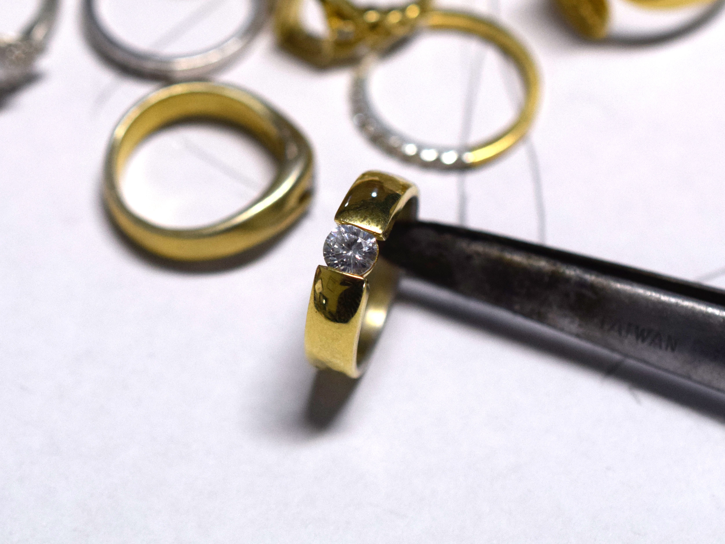 Silver draft, gold plated and set with a cubic zirconia of the approximate size.