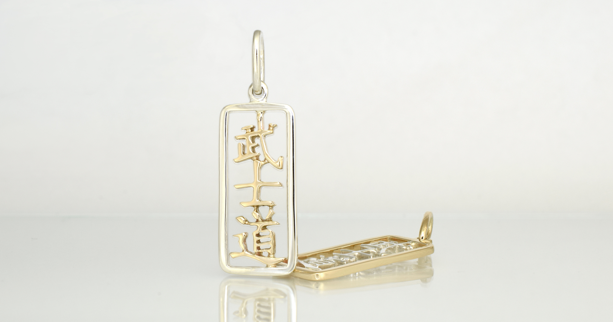 9ct yellow gold Kanji with Palladium Sterling Silver frame.