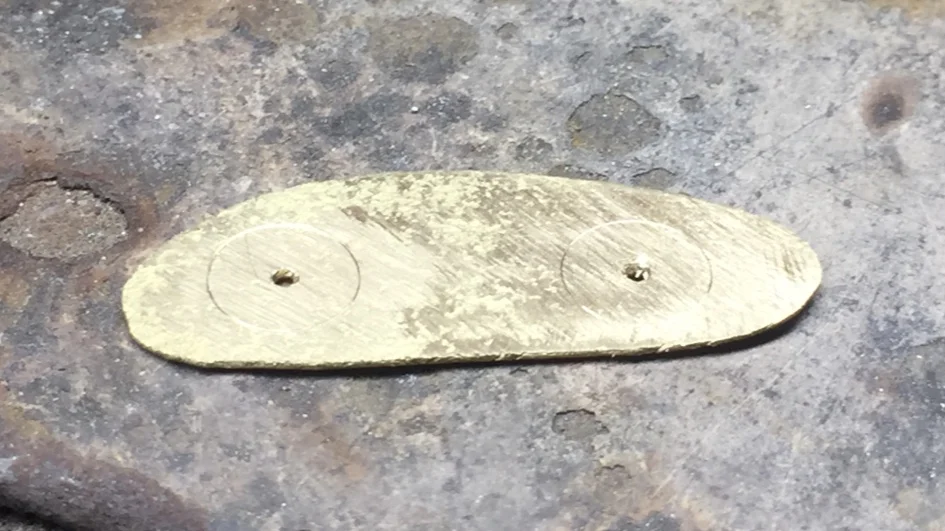 The cups traced and drilled in the plate.