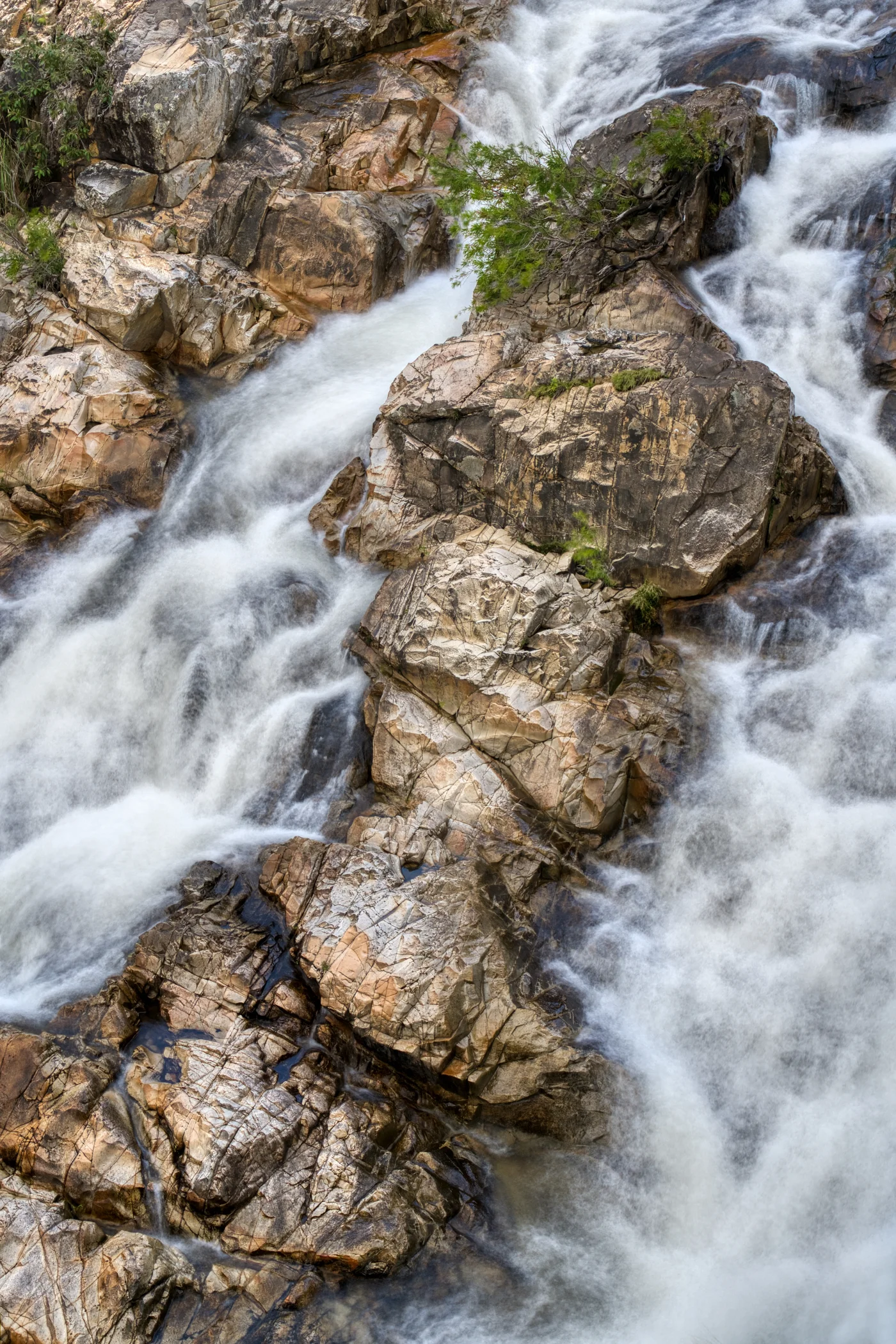 A small section of the falls with rocks protruding from the water.