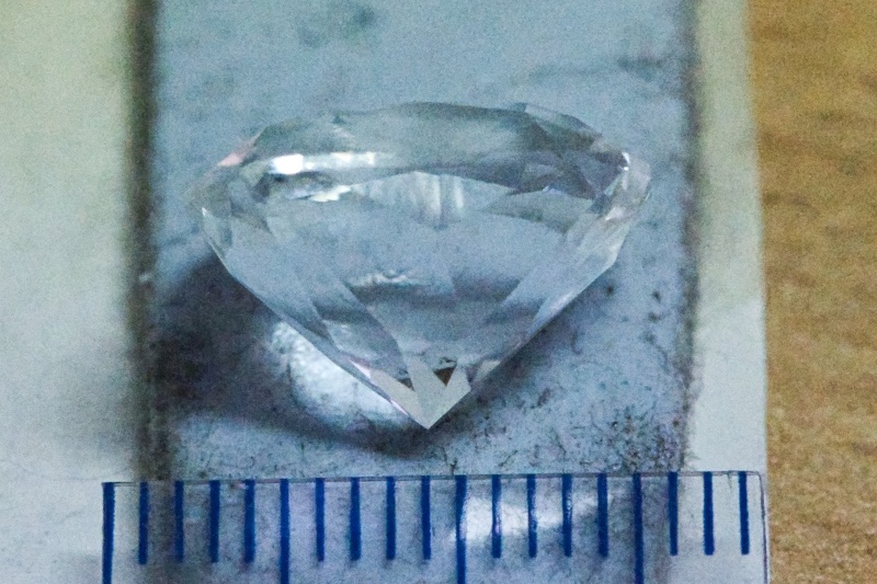  The bluetac colour visible through the gem. 