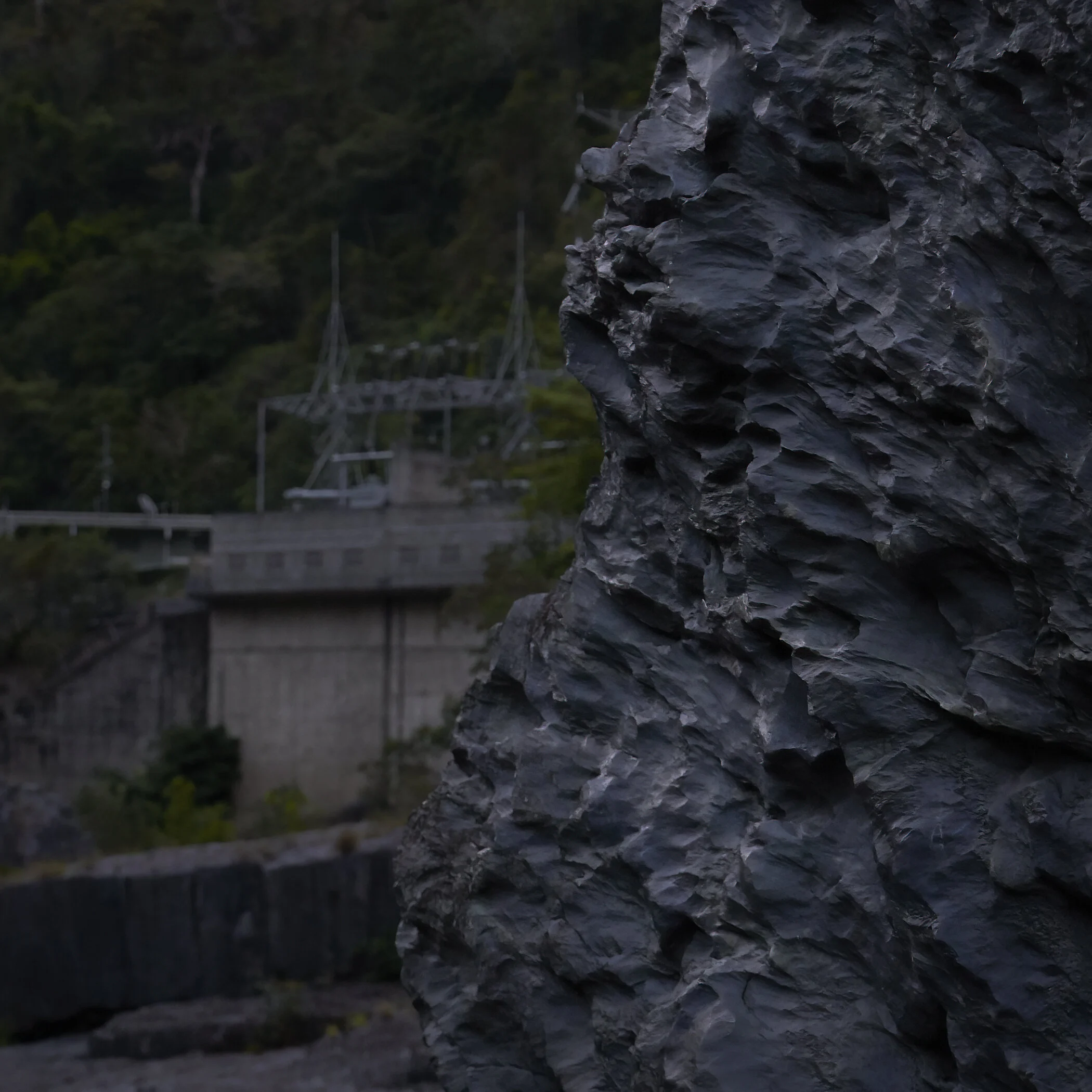 Darkness falling on the power station and the rocks