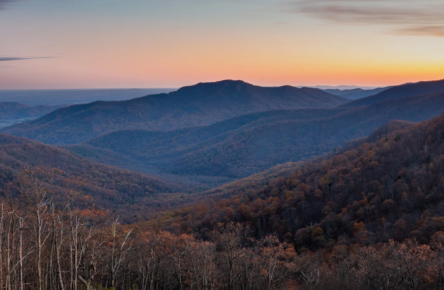 Golden hour photography over layered mountains with soft evening light in Shenandoah National Park