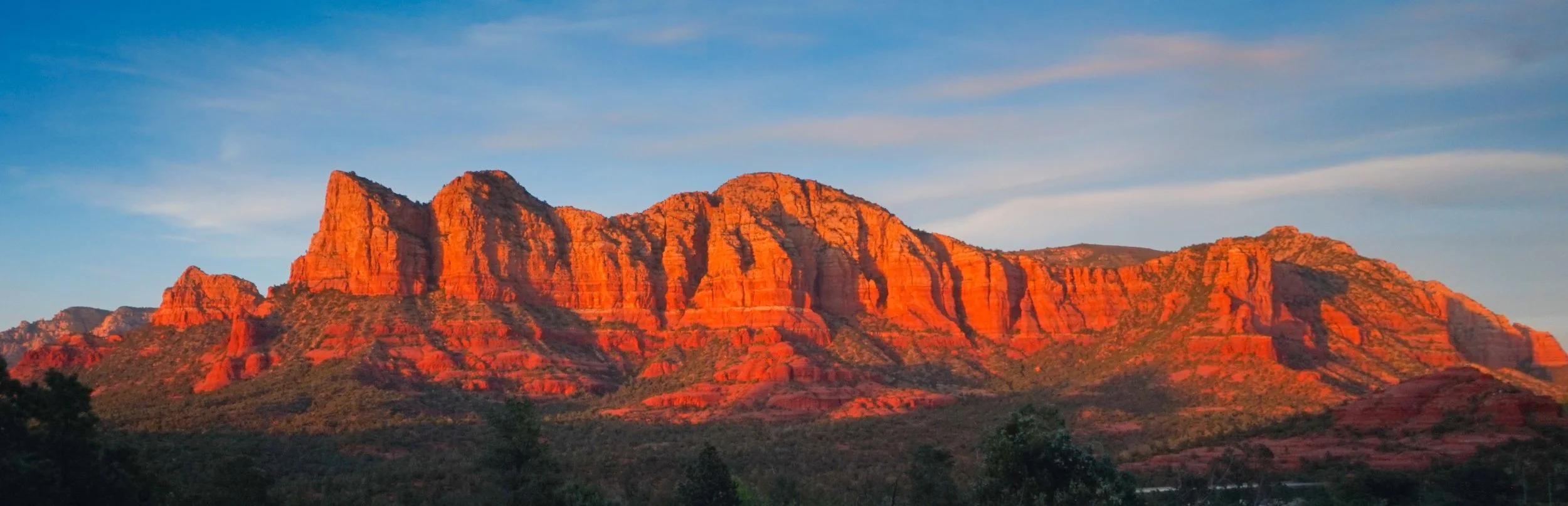 Red rock formations in Sedona Arizona glowing at sunset during landscape photography trip in the Southwest