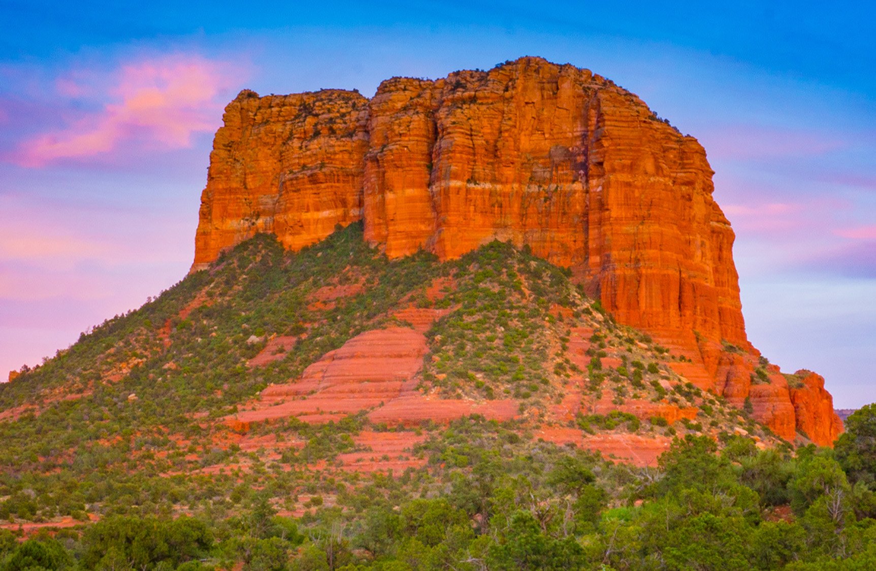 Cathedral Rock in Sedona Arizona at sunrise with red rock formations glowing in morning light during a Southwest road trip
