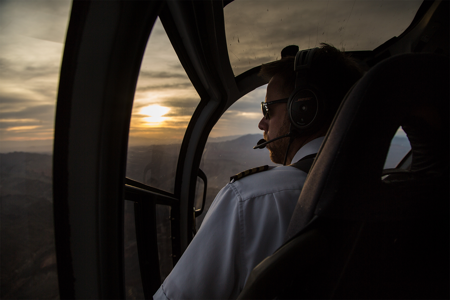 View from inside helicopter flying over the Grand Canyon at sunset