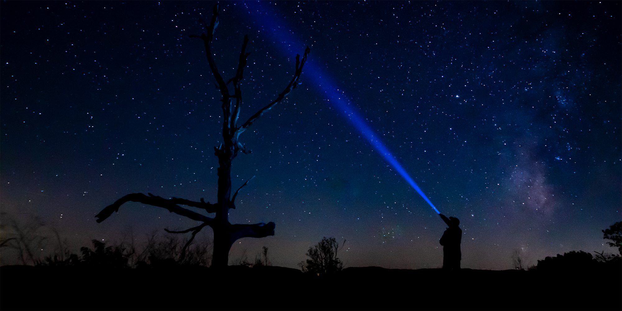 Person standing under the milky way at night in the Shenandoah national park