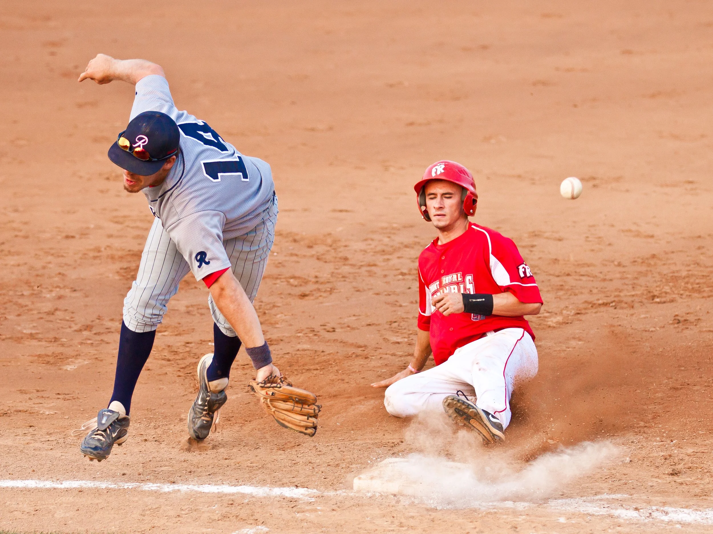 Two baseball players colliding at second base during a close play in a Valley League game in Front Royal, Virginia.