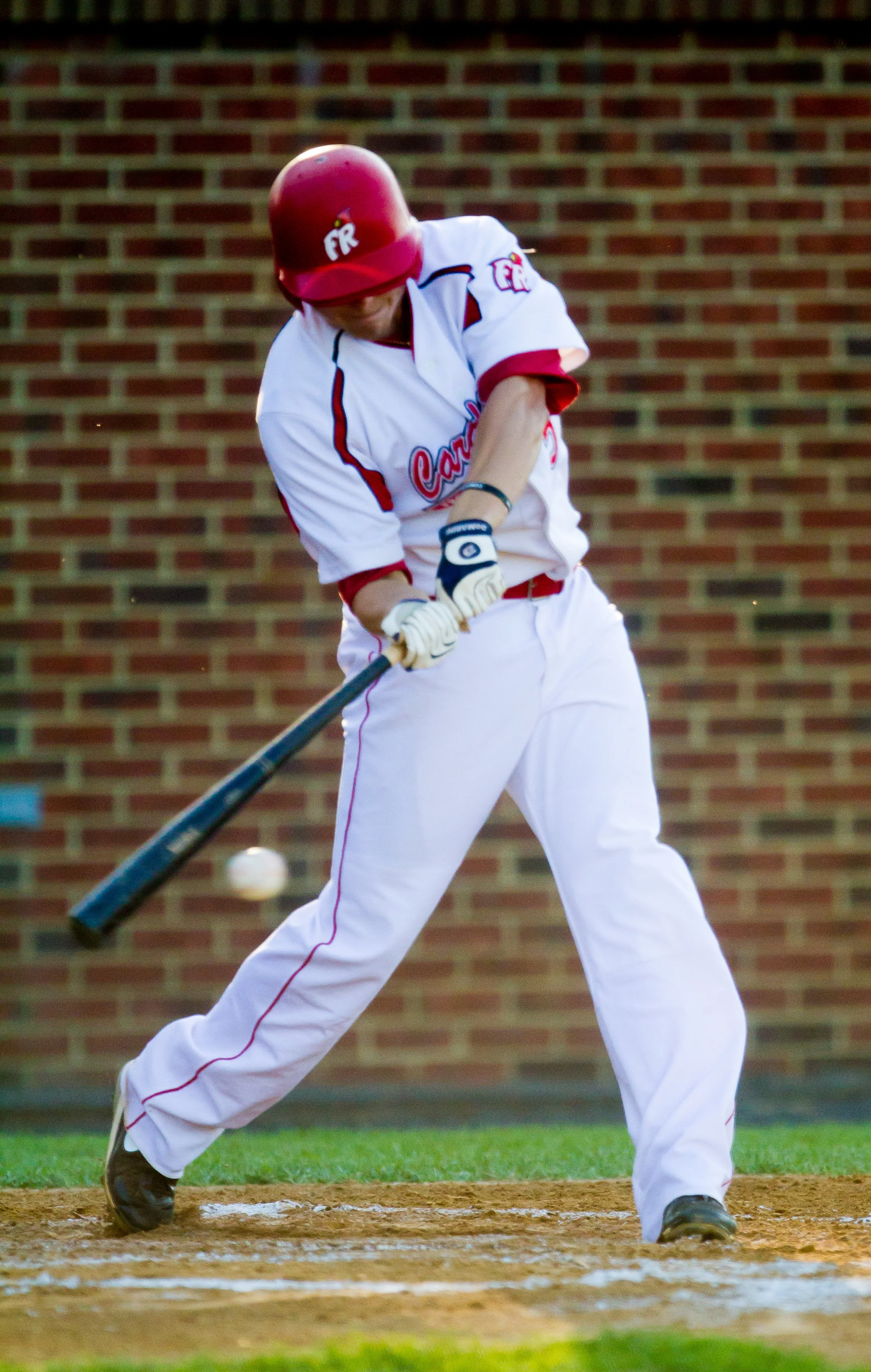 Front Royal Cardinals player swinging at a pitch during a Valley League baseball game in Front Royal, VA.