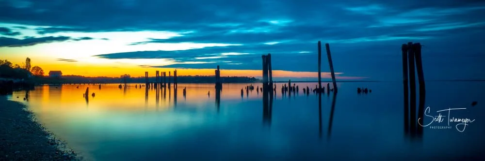 Blue hour photography over calm water with reflections and cool tones