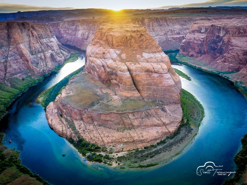 Golden hour light over Horseshoe Bend canyon with warm tones and river below