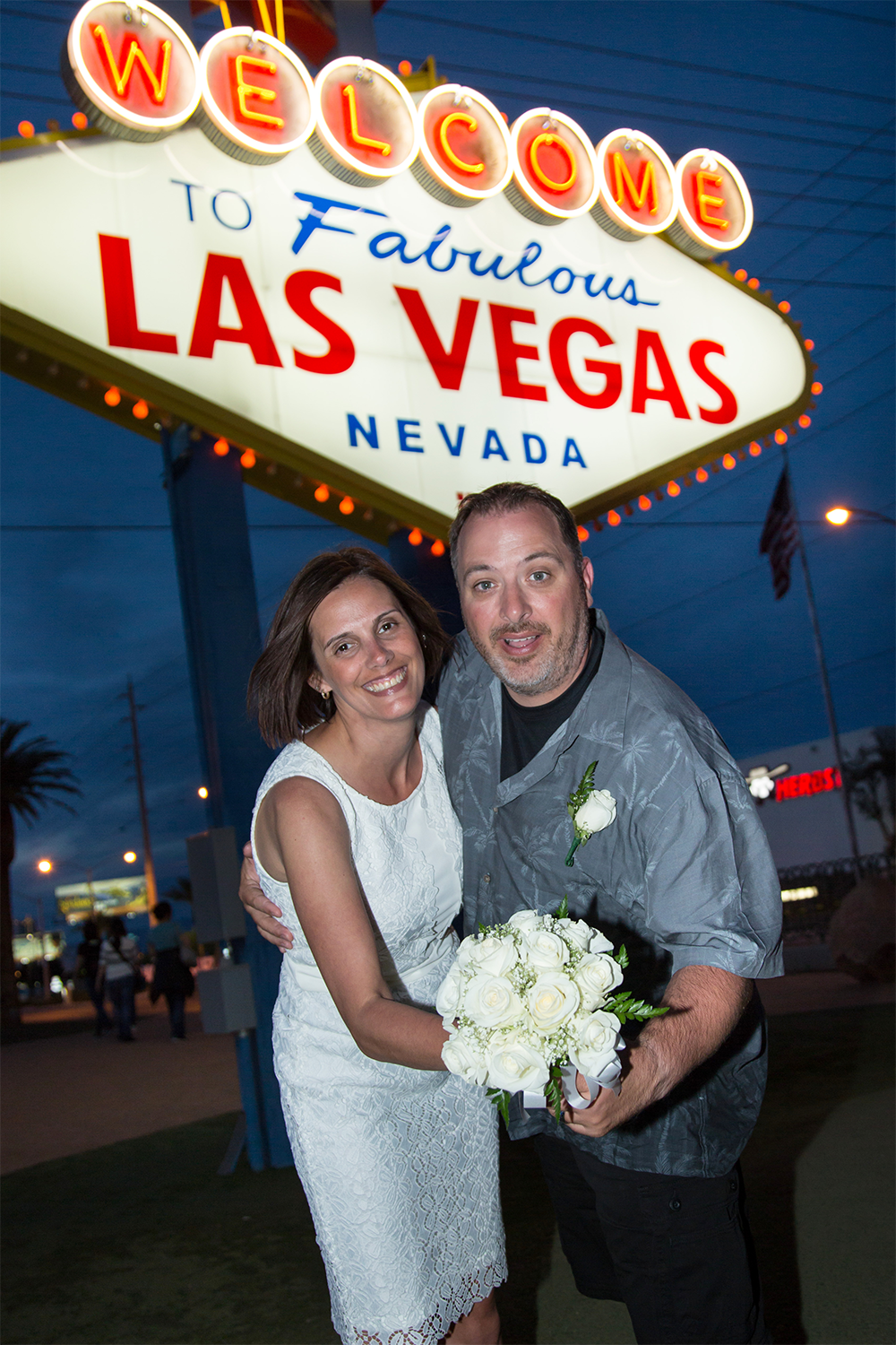 Wedding photo at Welcome to Fabulous Las Vegas Nevada sign at night
