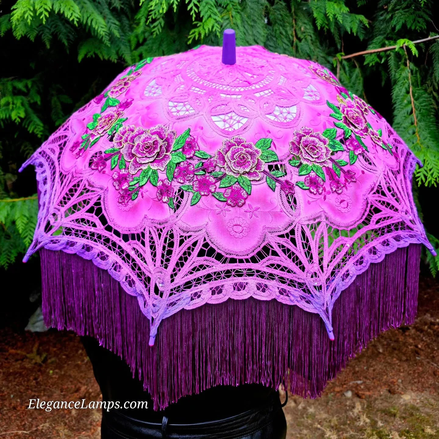 Two new parasols just landed.
One blooms in soft romance. It is hand‑dyed from dusty pink to purple, encircled in 3 D floral embroidery, trimmed in lush rayon fringe, and lit with delicate purple fairy lights.

The other is a full‑spectrum celebratio