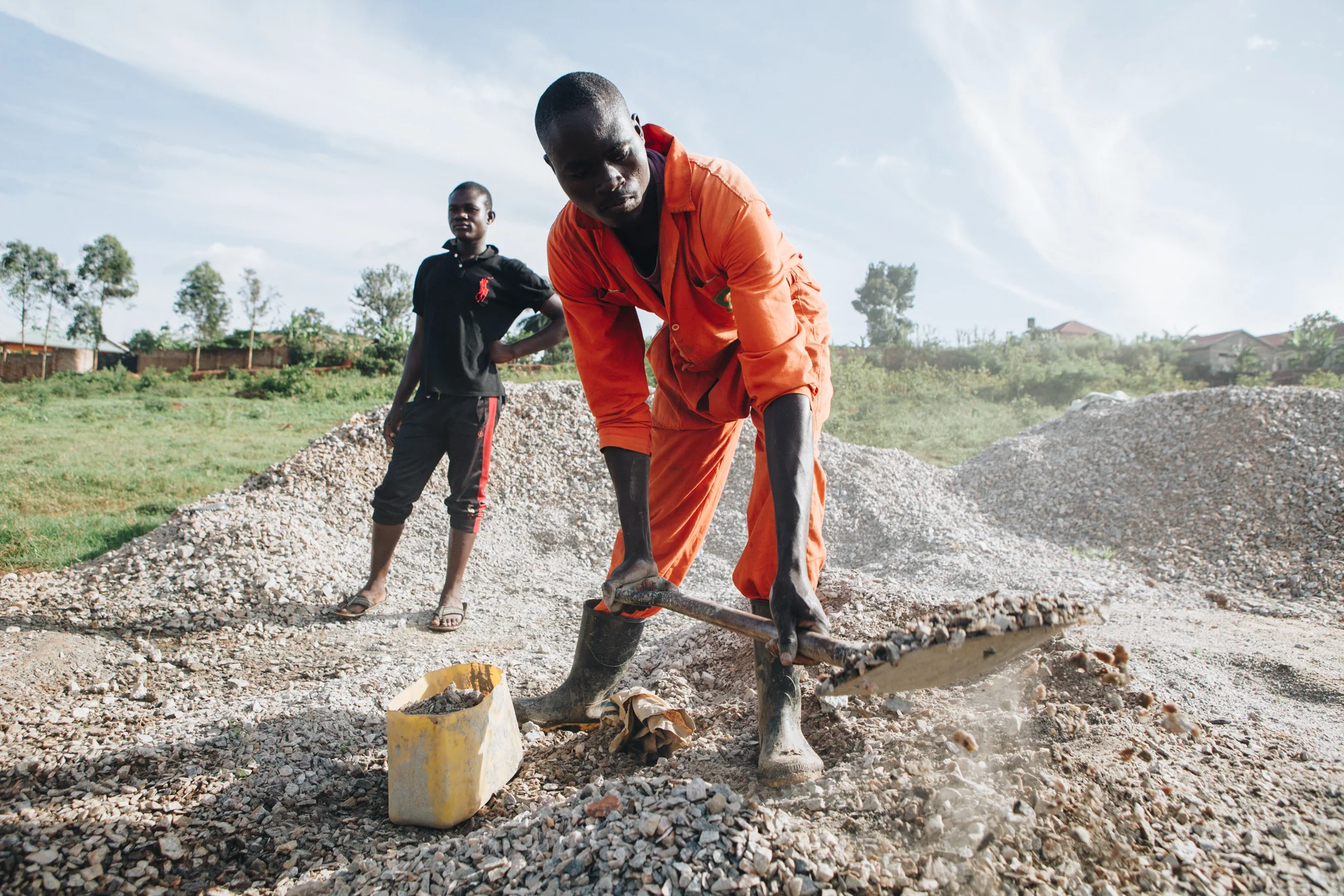 ©TomWoollard_Yunus-Social-Business-Uganda-African-work-man-shovelling-on-construction-site.jpg