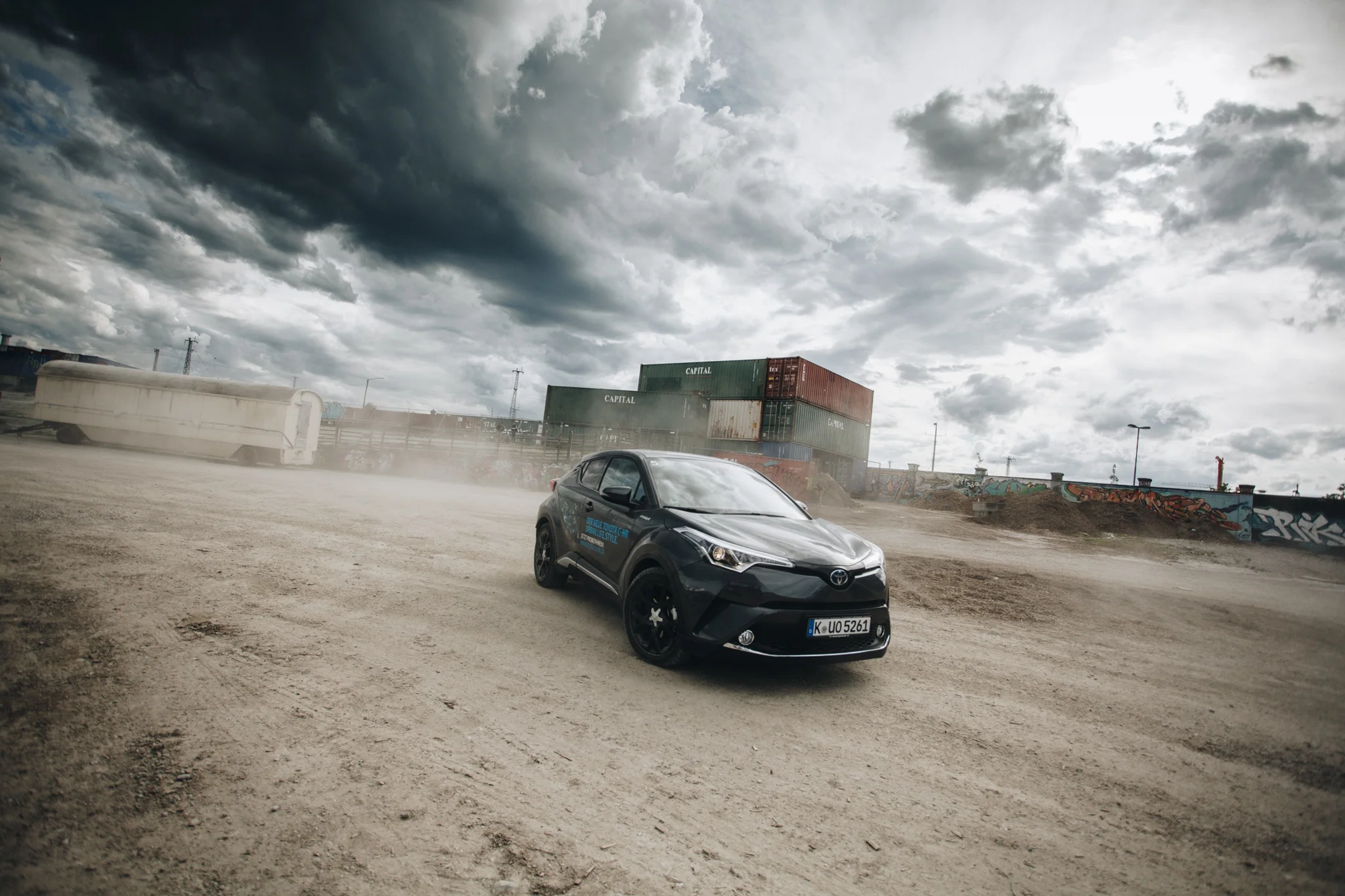 ©TomWoollard_Toyota_CHR_car-on-urban-dirt-wasteland-with-dramatic-clouds-sky-Munich-editorial.jpg