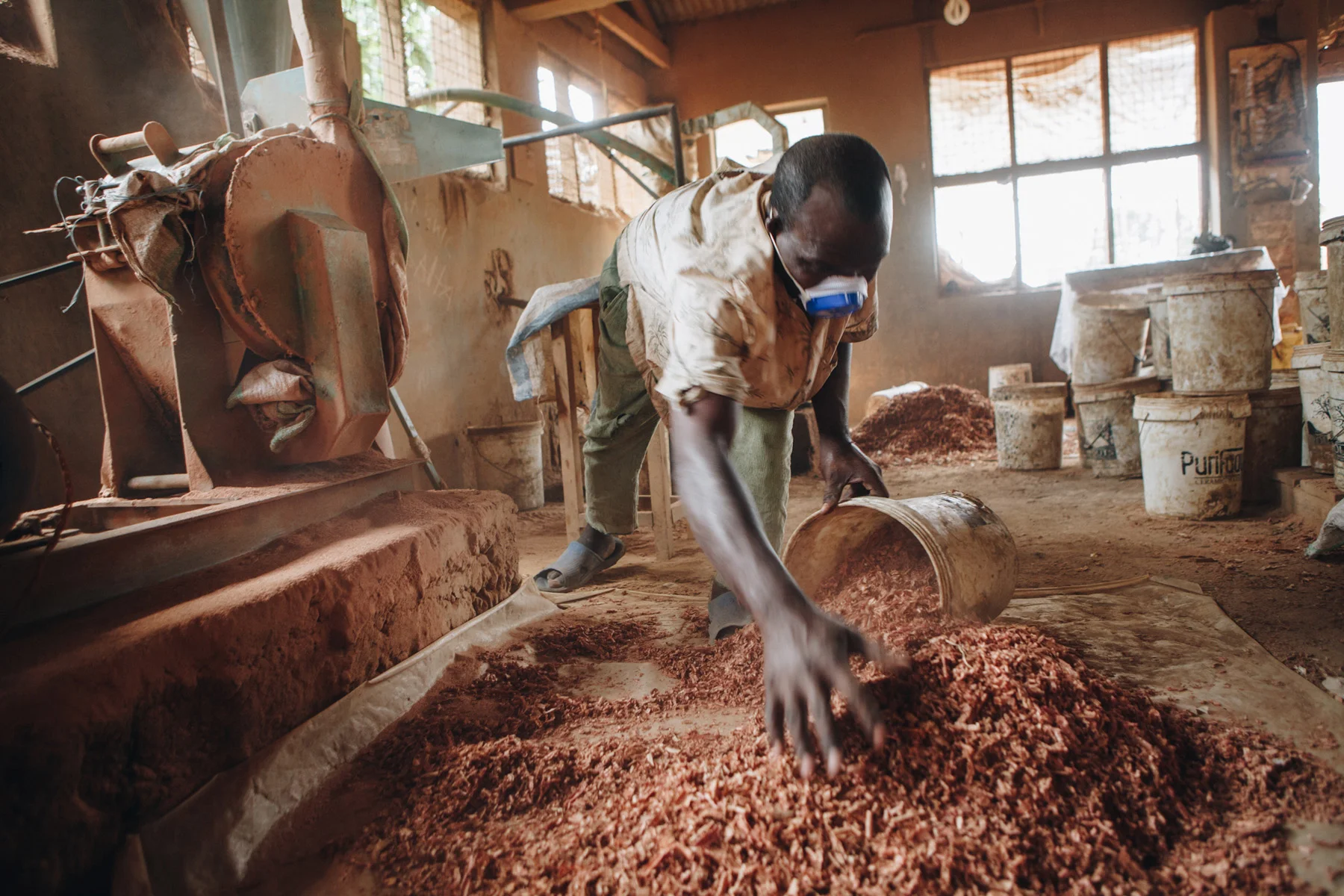 ©TomWoollard_Yunus-Social-Business_Uganda-spoutsofwater-african-man-working-dusty-workshop-editorial.jpg