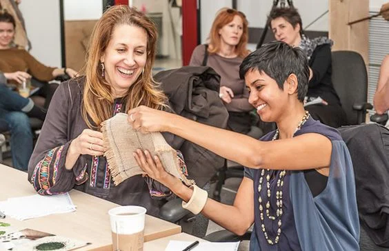 Sumitra and Lori reviewing student work at PhillyU