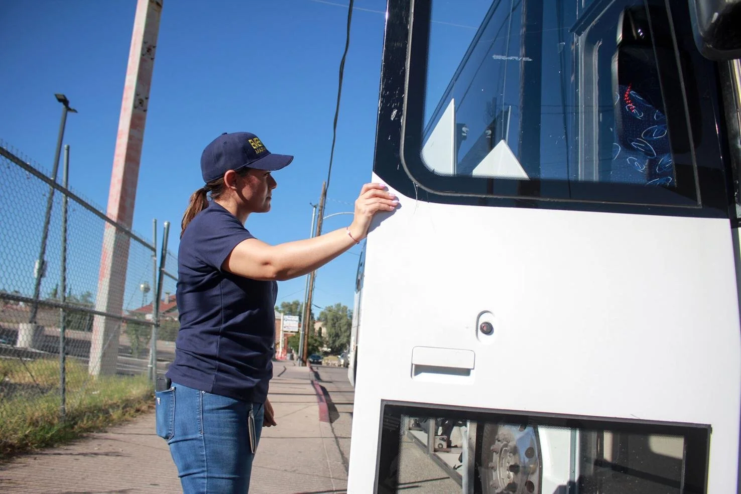  Santa Cruz County Emergency Management Director Sobeira Castro pauses after assisting asylum-seekers onto a bus destined for Tucson, Ariz. 