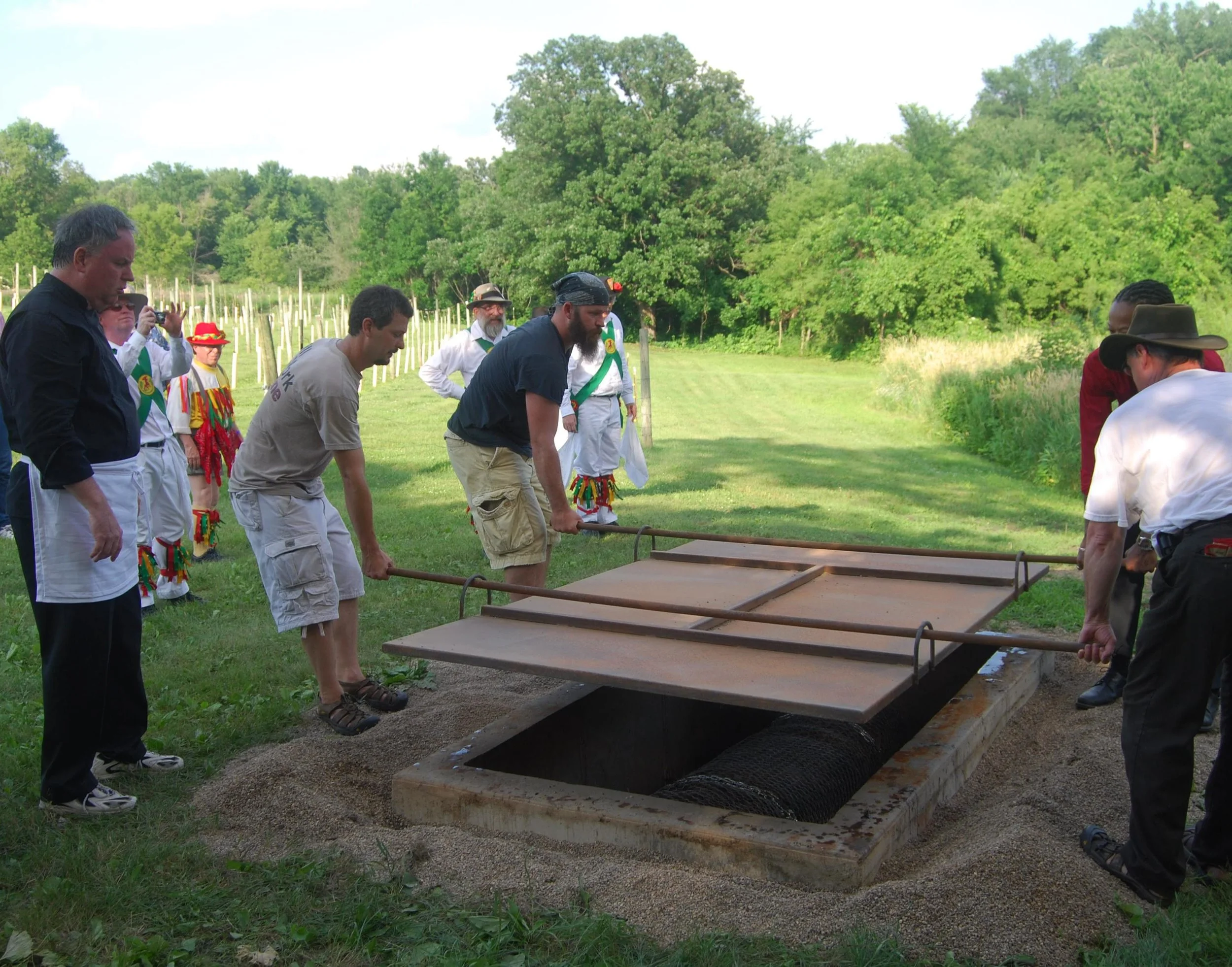 Closing the pork-roasting pit for the "Farm to Fork Wine Dinner."