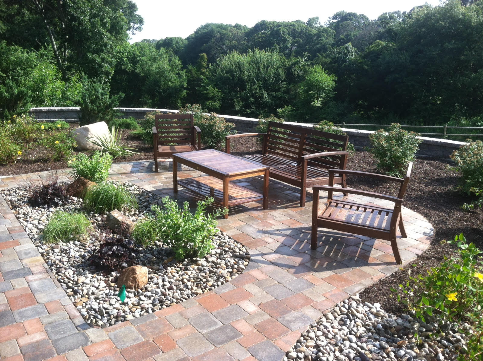 Paver patio with retaining wall and plantings in West Greenwich, RI