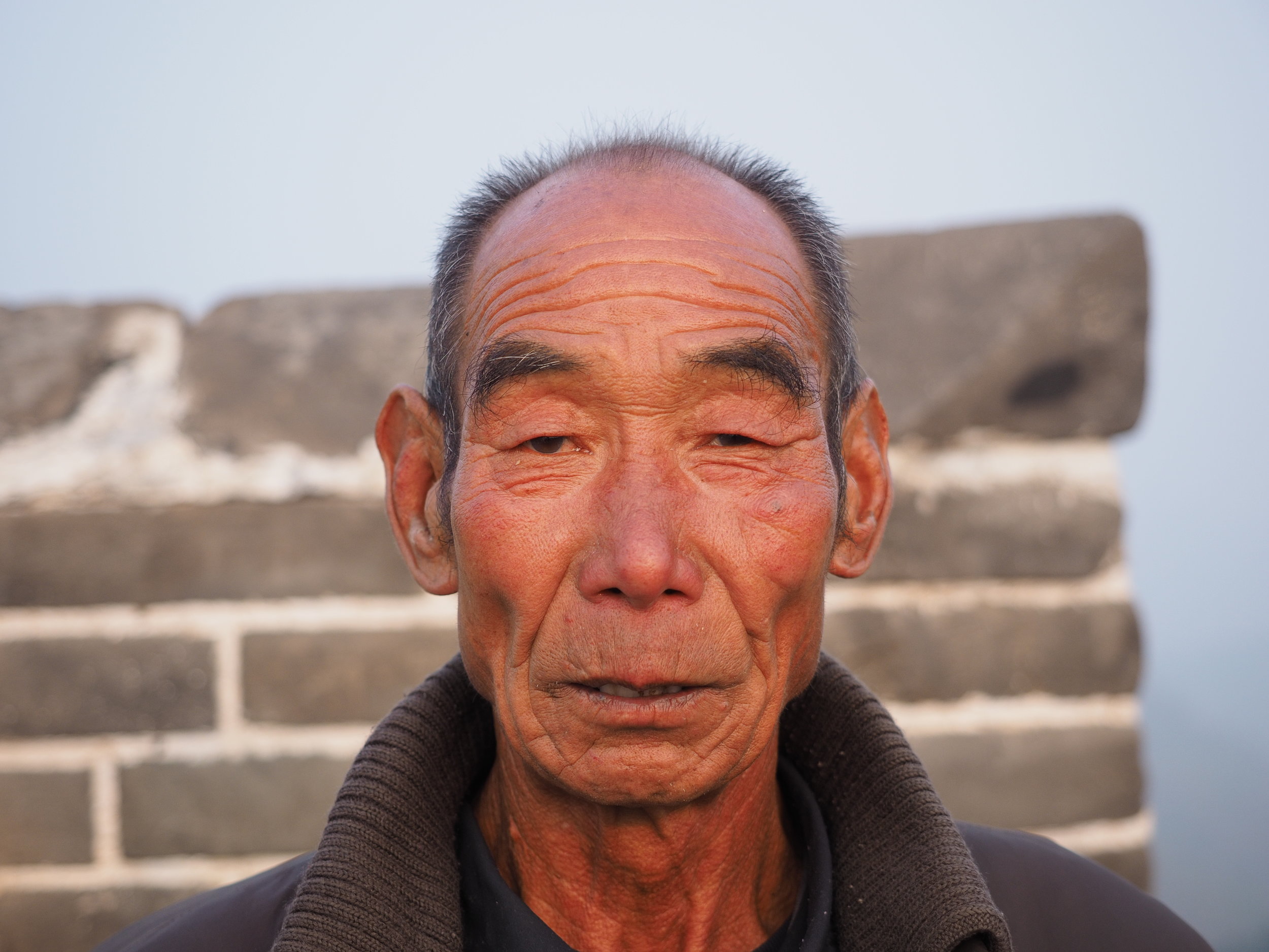 An old man selling drinks on the Great Wall. I had an iced coffee.