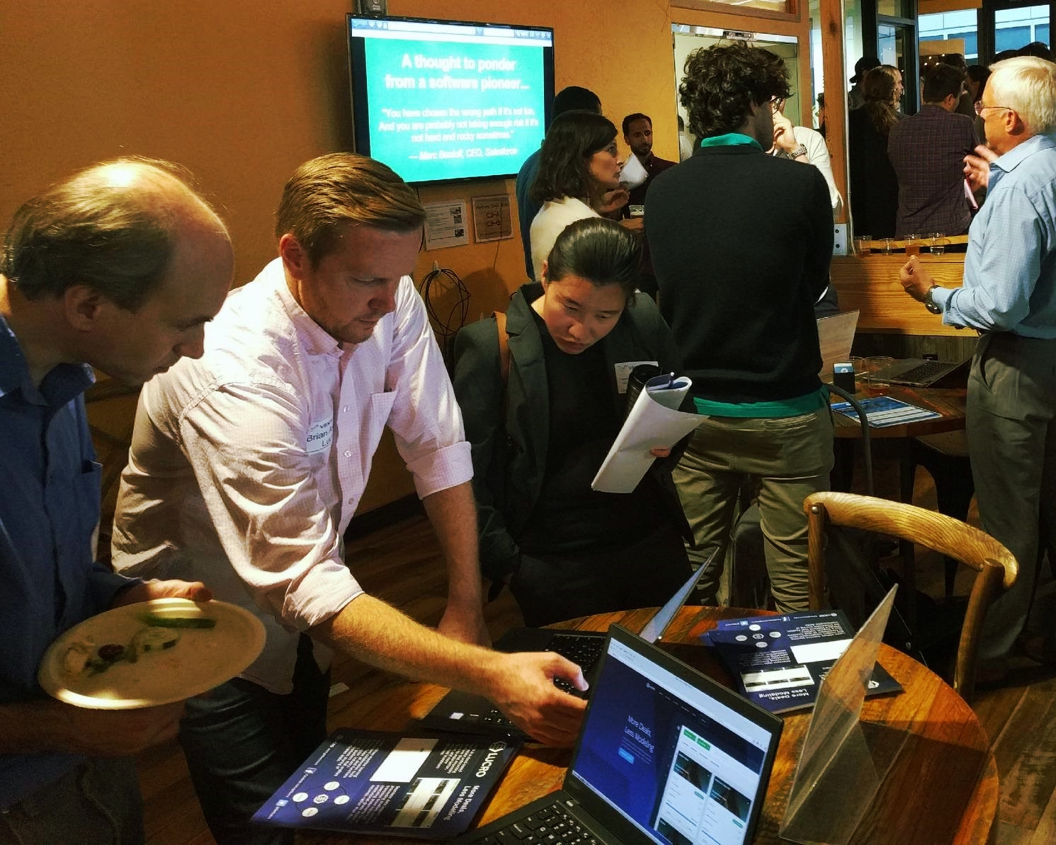 Brian Axline, founder and CEO of Lucro (second from left) demos the product to FinTech Connect attendees.