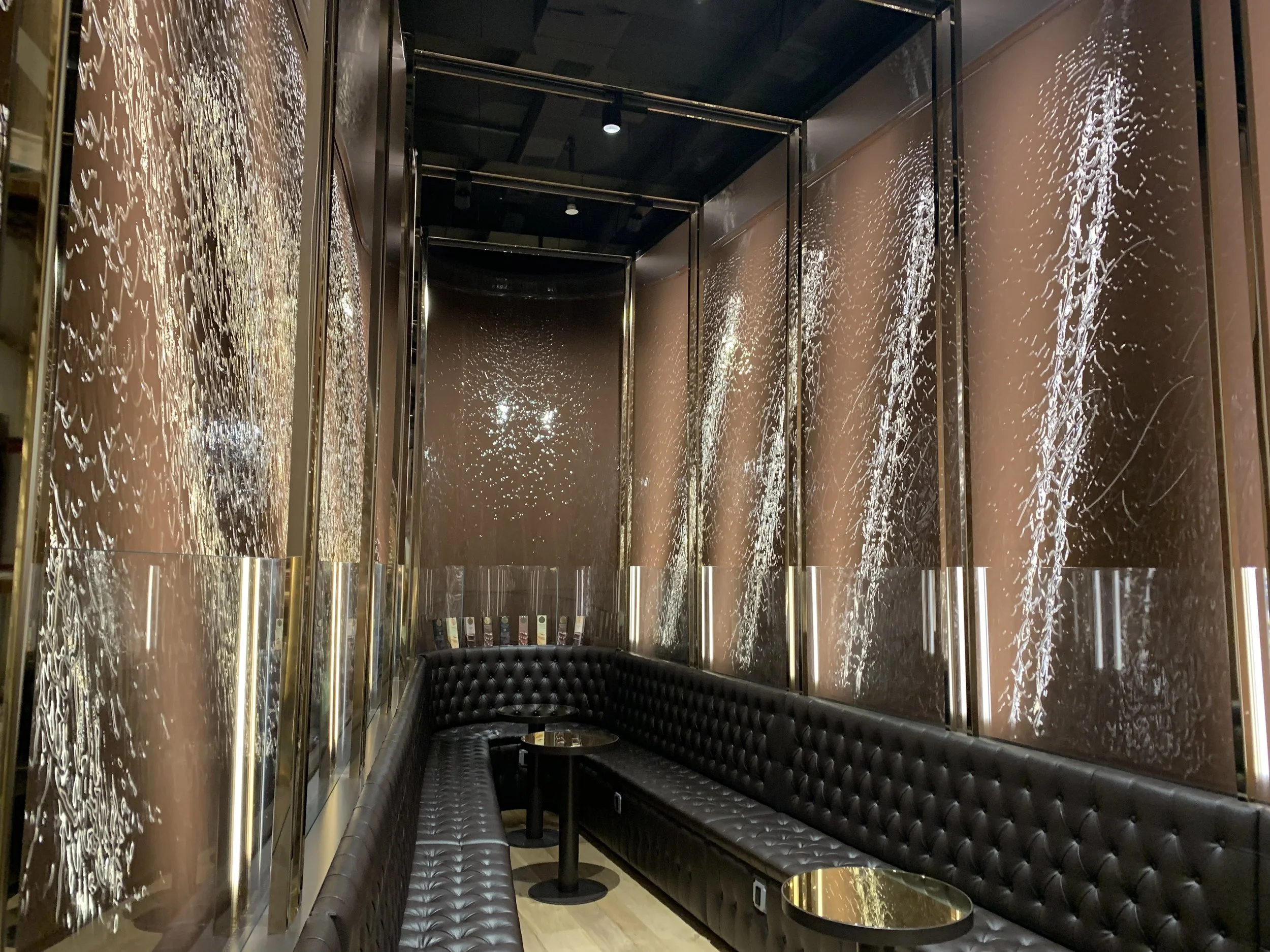 Enjoy espresso, gelato, pastries and more in the presence of a chocolate waterfall at Venchi.