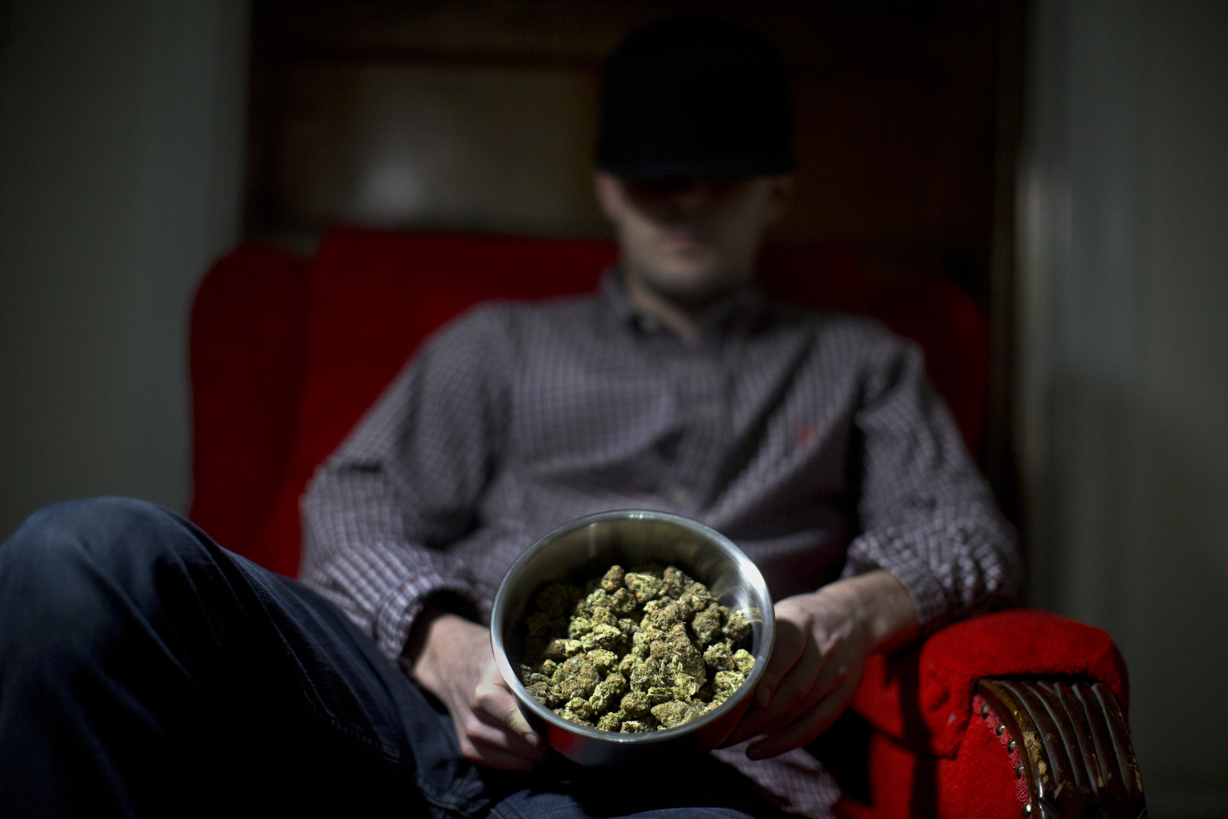 A drug dealer displays the marijuana he sells in his living room in Washington, DC.