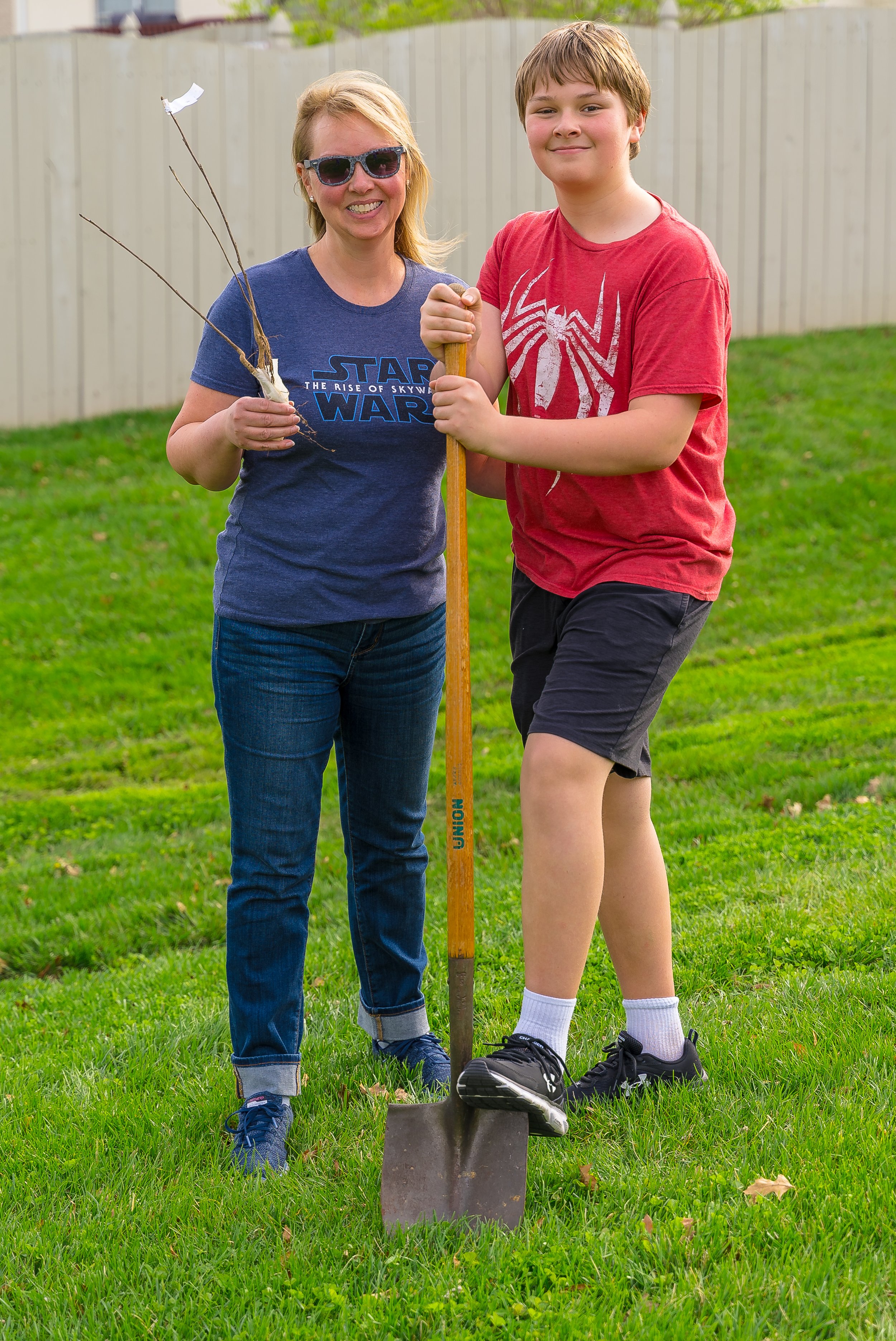 Attorney Laura A. Scott And Son Planting A Tree.jpg