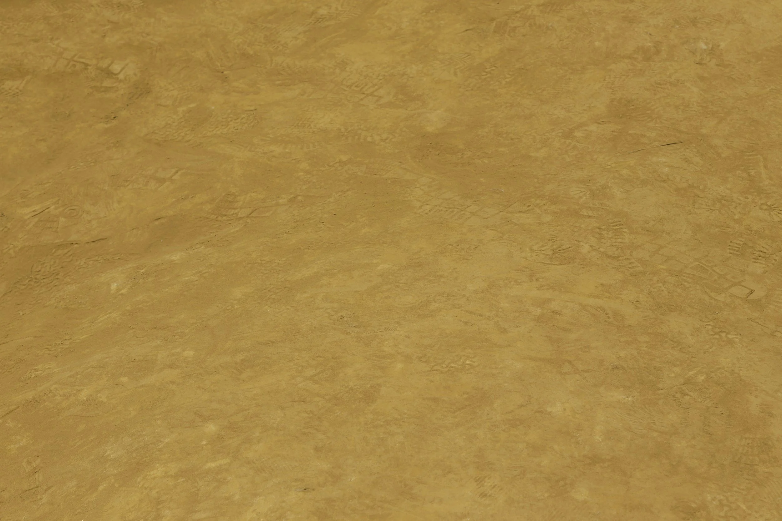 A close-up of a clay plaster with a natural light orange color and visible textured patterns.