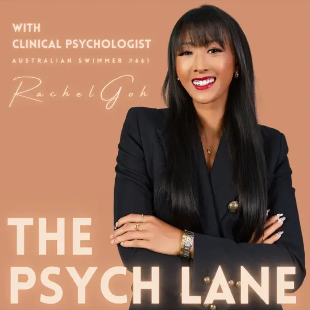 A woman with long black hair, wearing a black blazer, smiling, with her arms crossed, and gold jewelry, in front of a peach background that has text about an interview with clinical psychologist Rachel Goh for The Psych Lane podcast