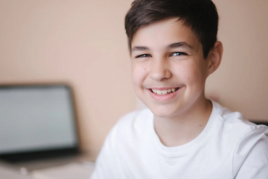 bigstock-Happy-Teenage-Boy-Sits-By-The--361352371 (1).jpg