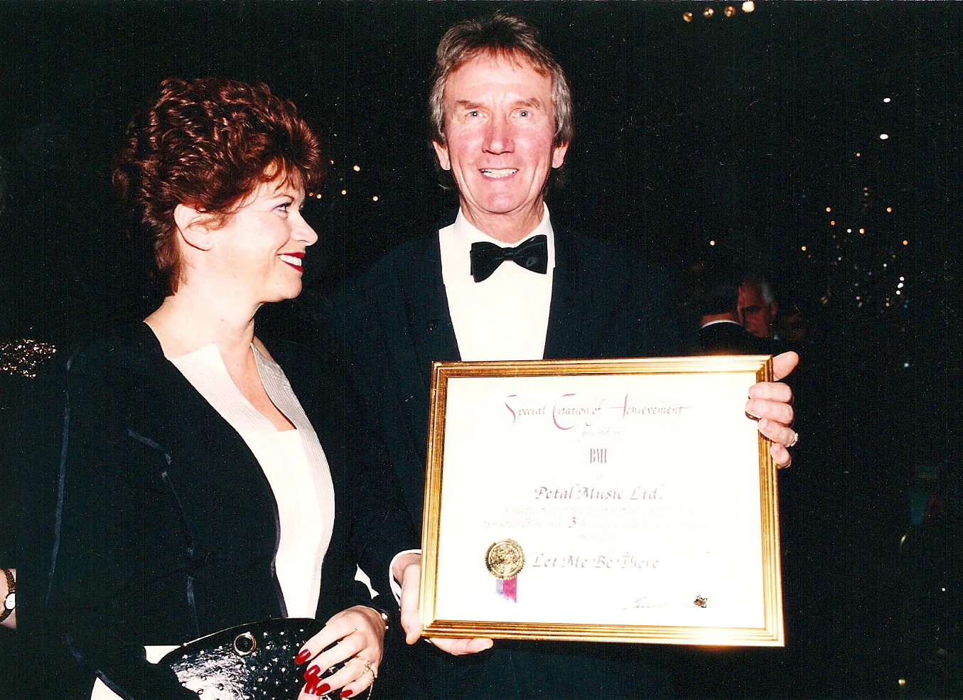 AWARDS - Chris smiles at this award copy.jpg