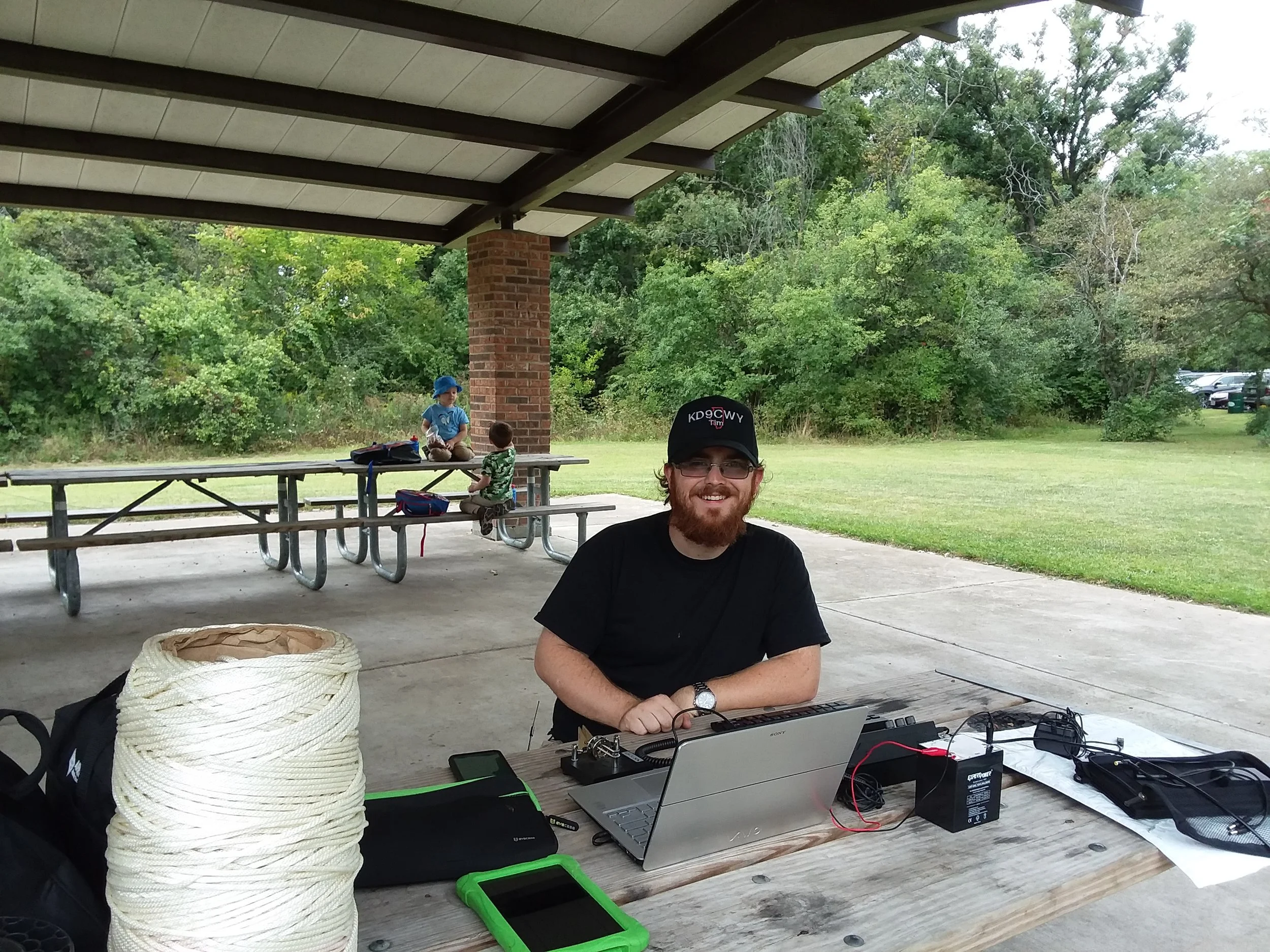 Tim (KD9CWY) with his set-up, and his sons Archer and Hunter (the future "Super Hams") in the background.