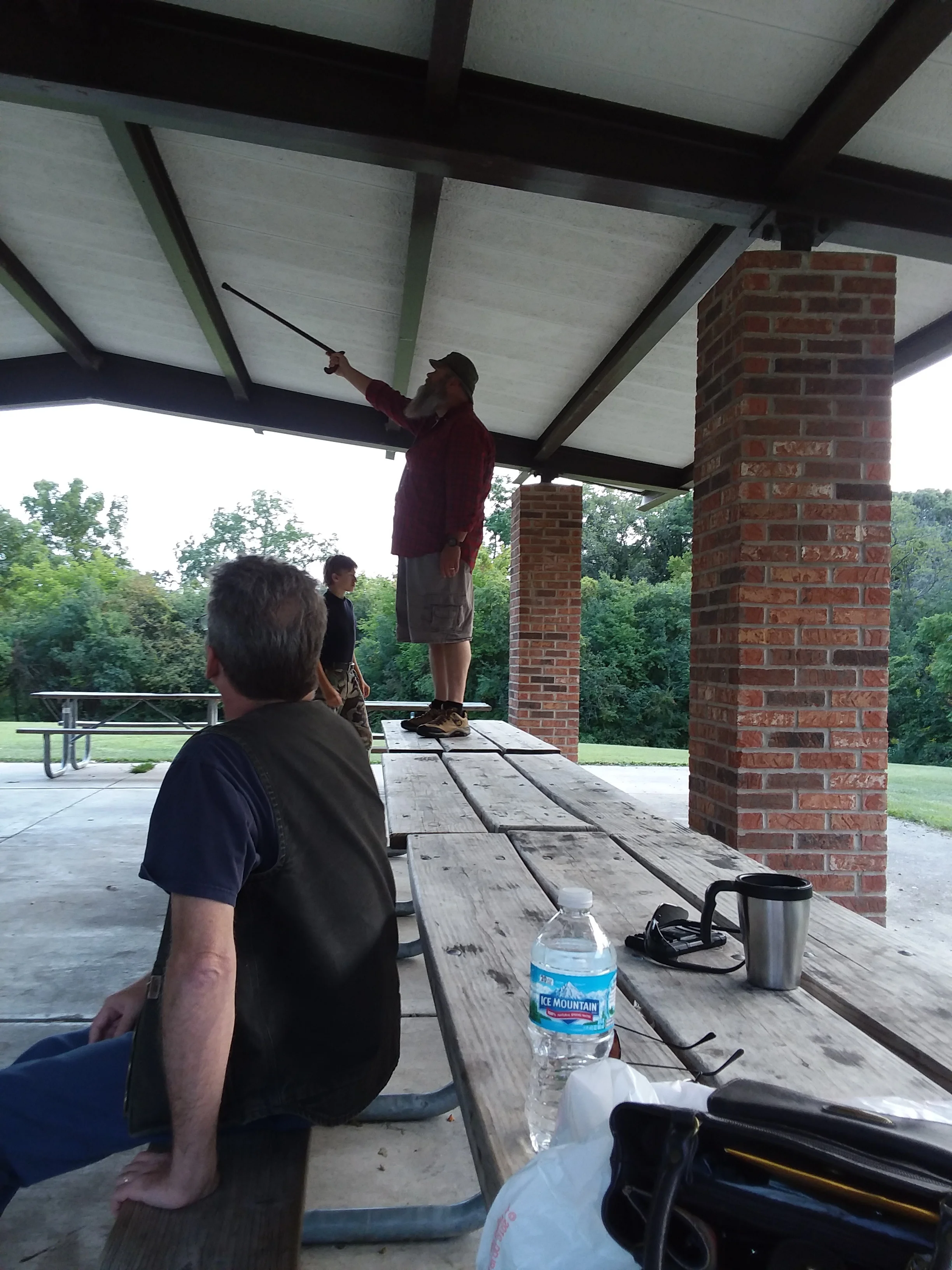 Mike (N9PLG), Kyle (Strango), and John (KD9BYW). BYW pointing out nature in the upper foundation of the outdoor structure.