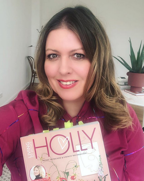 HOLLY Becker holding HOLLY magazine