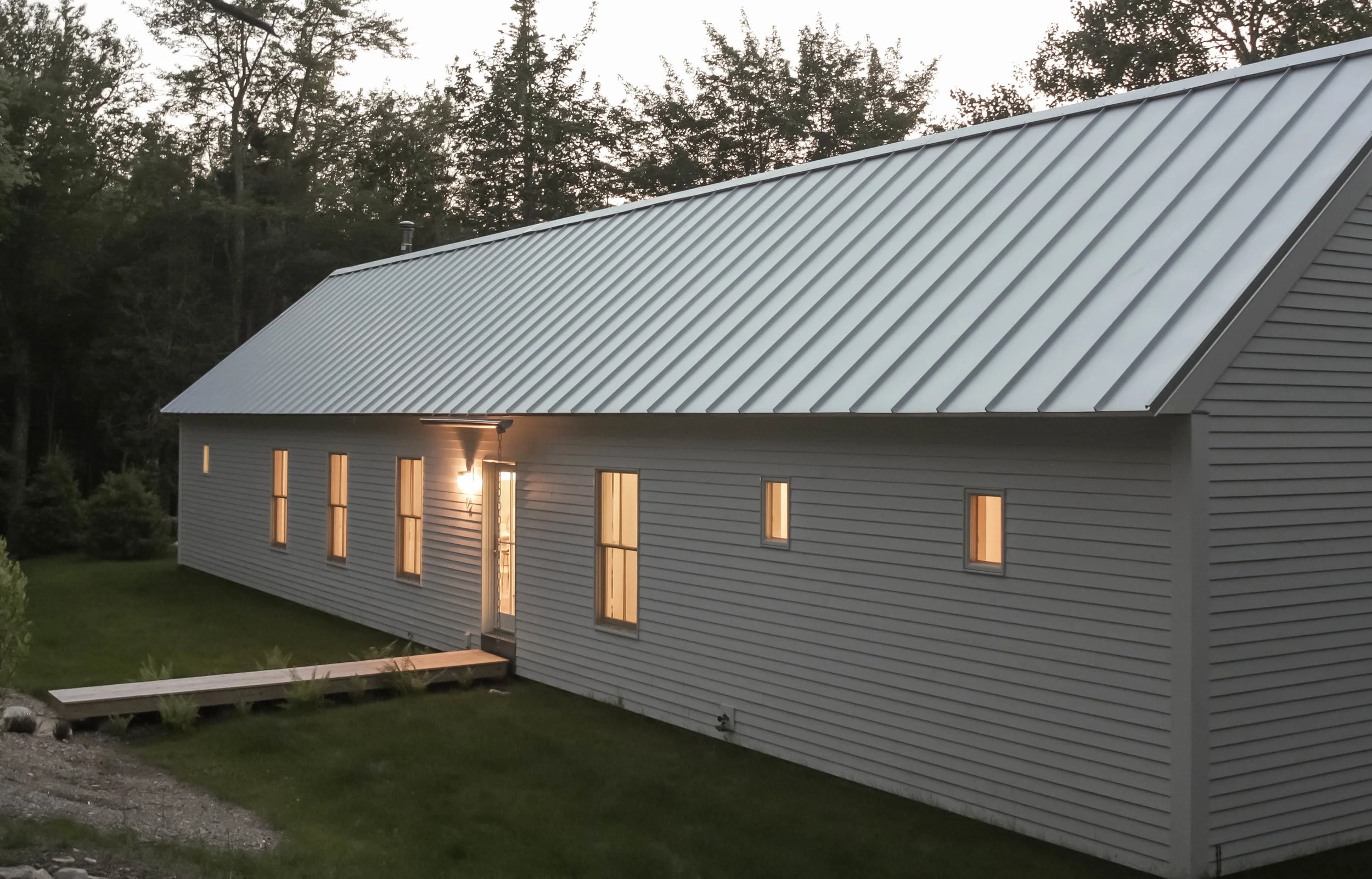 The Longhouse - Exterior and Entry Boardwalk | Dusk