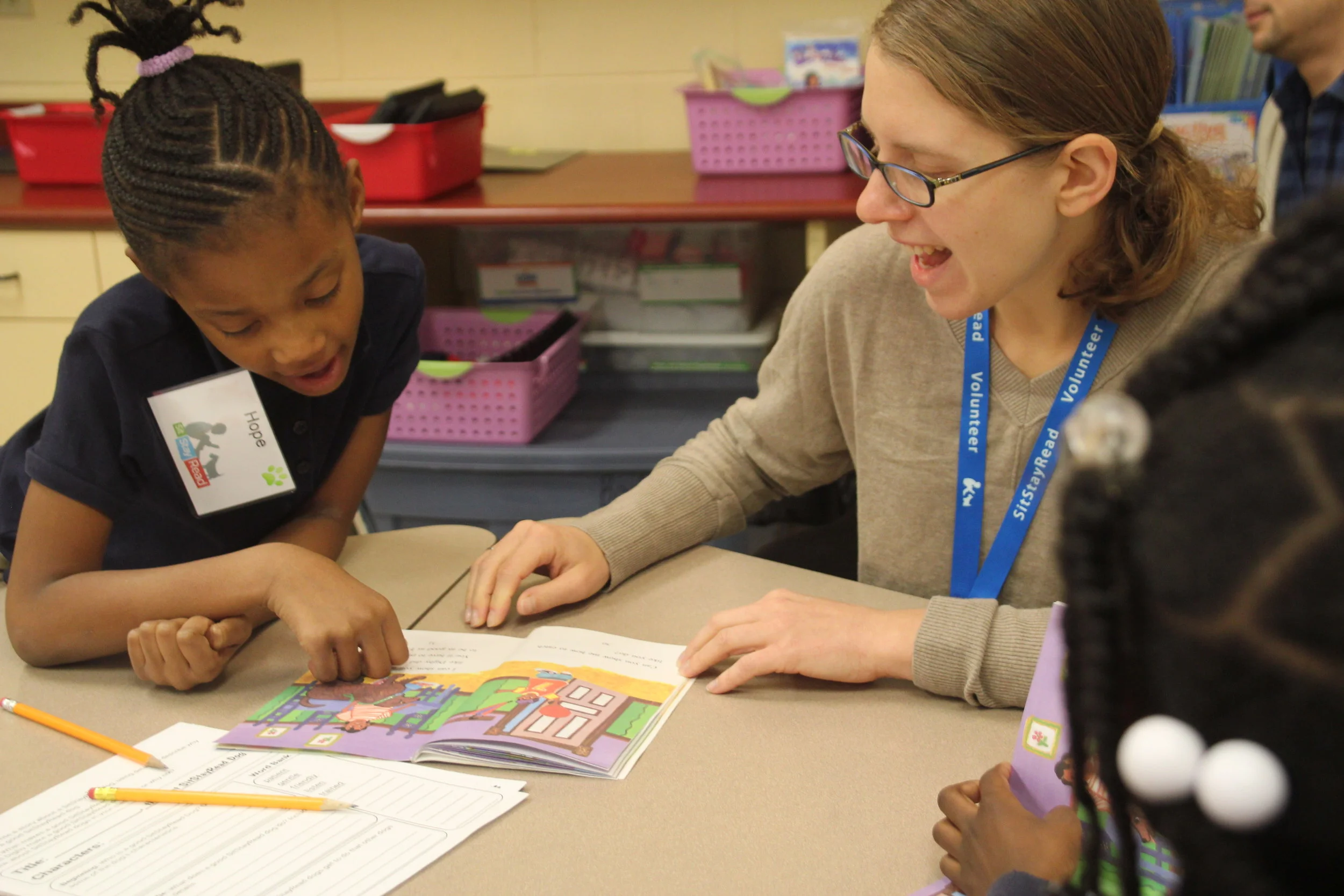 Book Buddy volunteer Amanda works with a second-grade student on their reading skills in a Tail Blazers program. (M. OBrien)