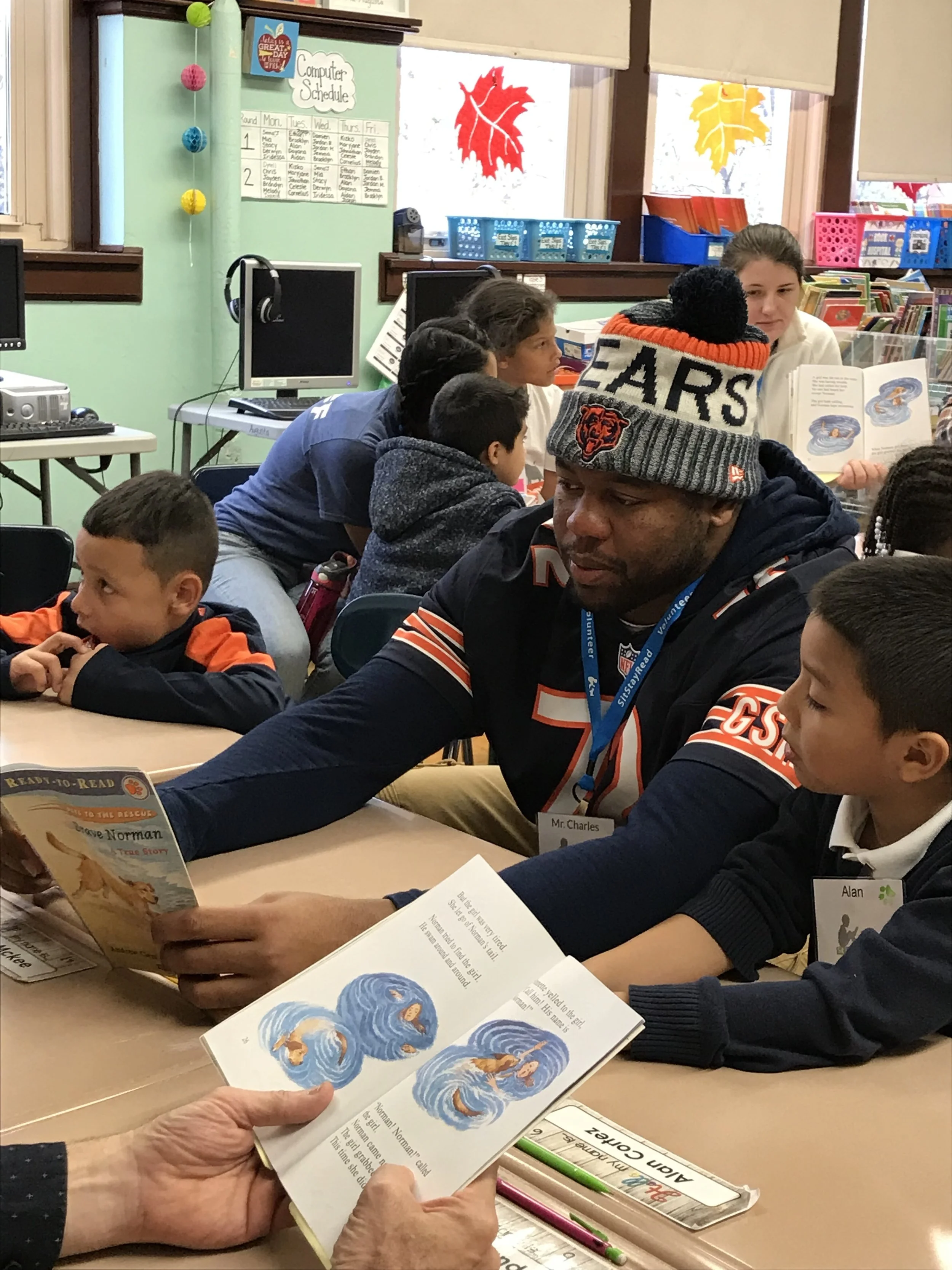 Charles Leno Jr. reads Brave Norman with second-grader Alan at Lowell Elementary.