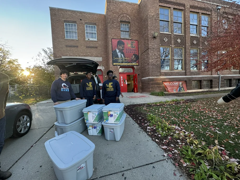 Evan and 8th graders unloading.JPEG