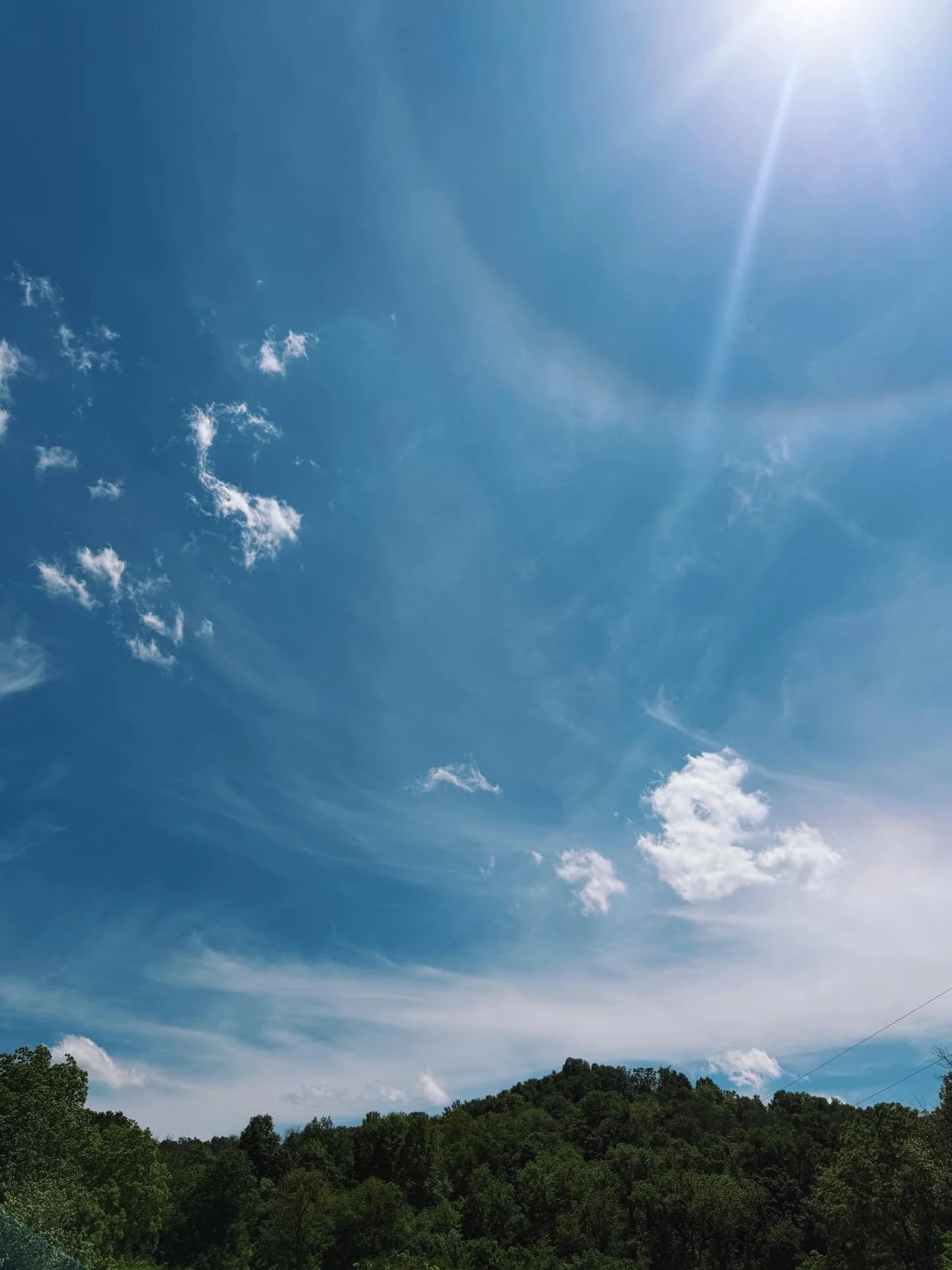 Brilliant blues in the sky and soil yesterday. 💙 And a solar halo! Have you ever seen one? 

A solar halo is a faint rainbow around the sun, caused by sunlight refracting through millions of hexagonal ice crystals in high-altitude cirrus clouds. The