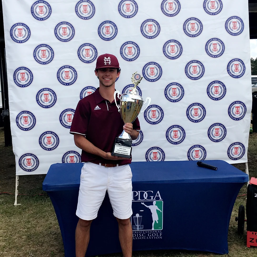 Jacob Henson celebrating his team's victory at the National Collegiate Disc Golf Championship.