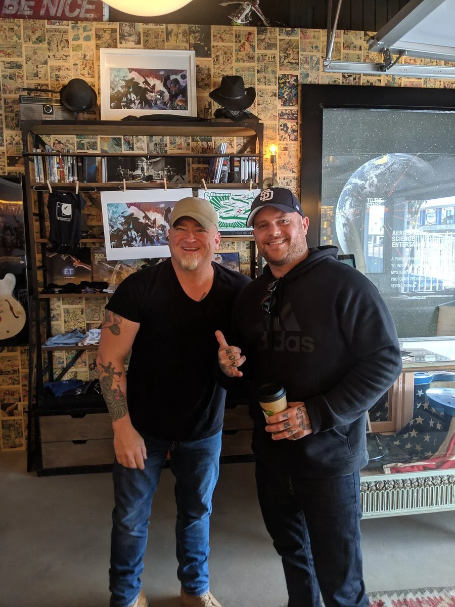 Luis Elizondo is kind enough to treat Geoff Boon and a friend to To The Stars merch. (Geoff Boon.)