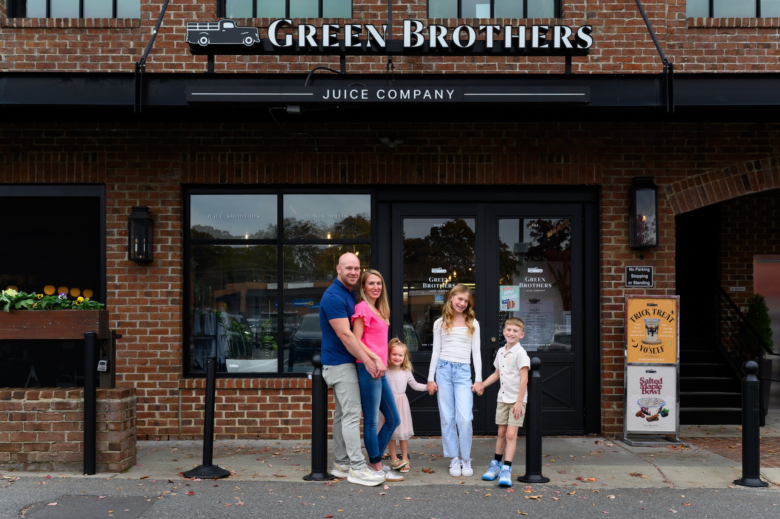 Family in front of green brothers