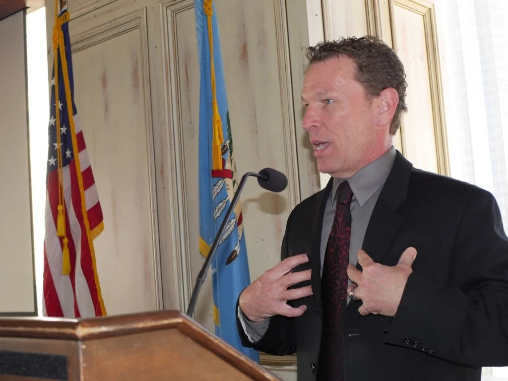 Michael D. Morrison speaking at a podium at a business event