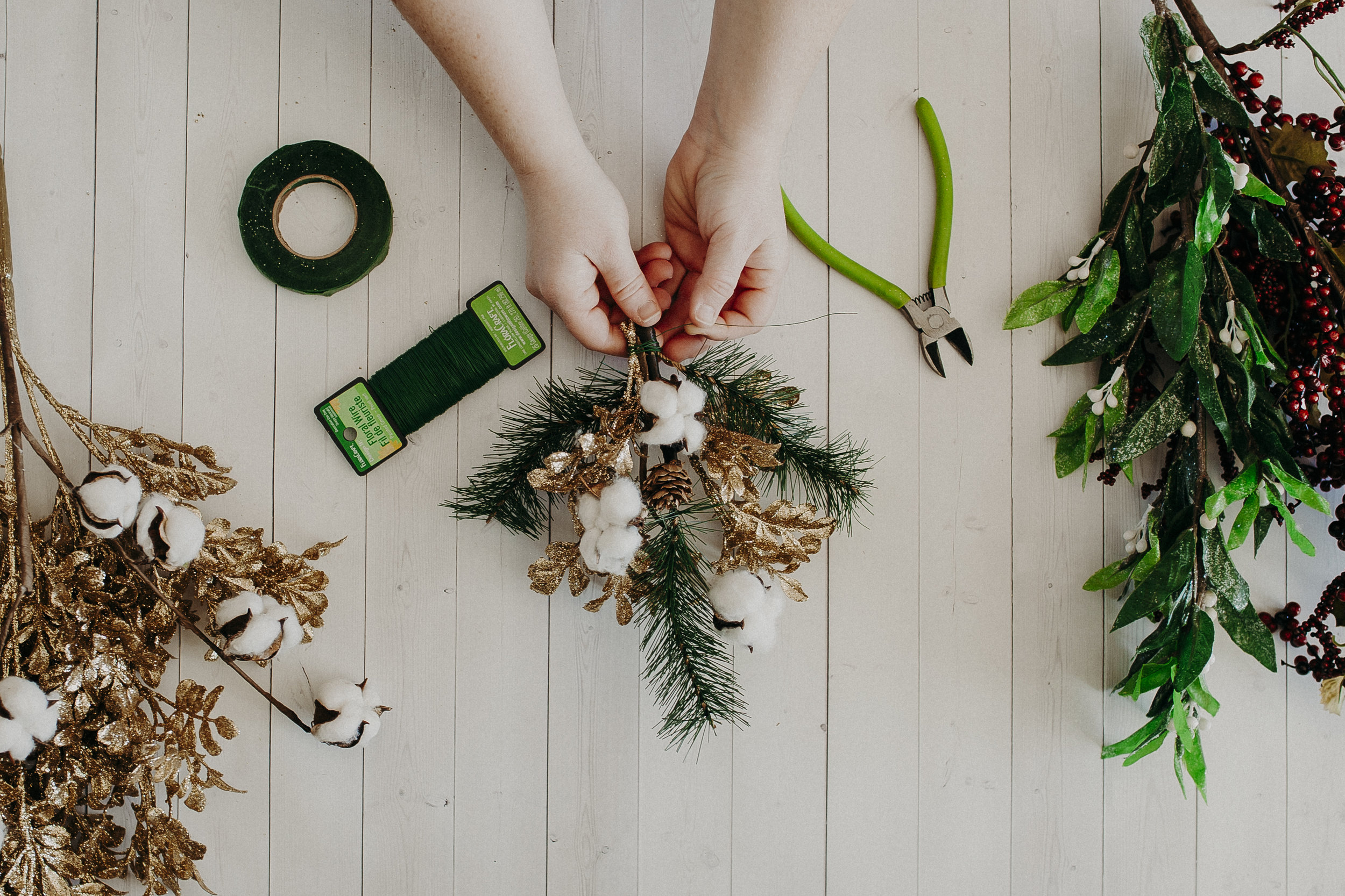  Step 2 -&nbsp;  Arrange your garland pieces to create your perfect sprig, then secure them with floral wire 