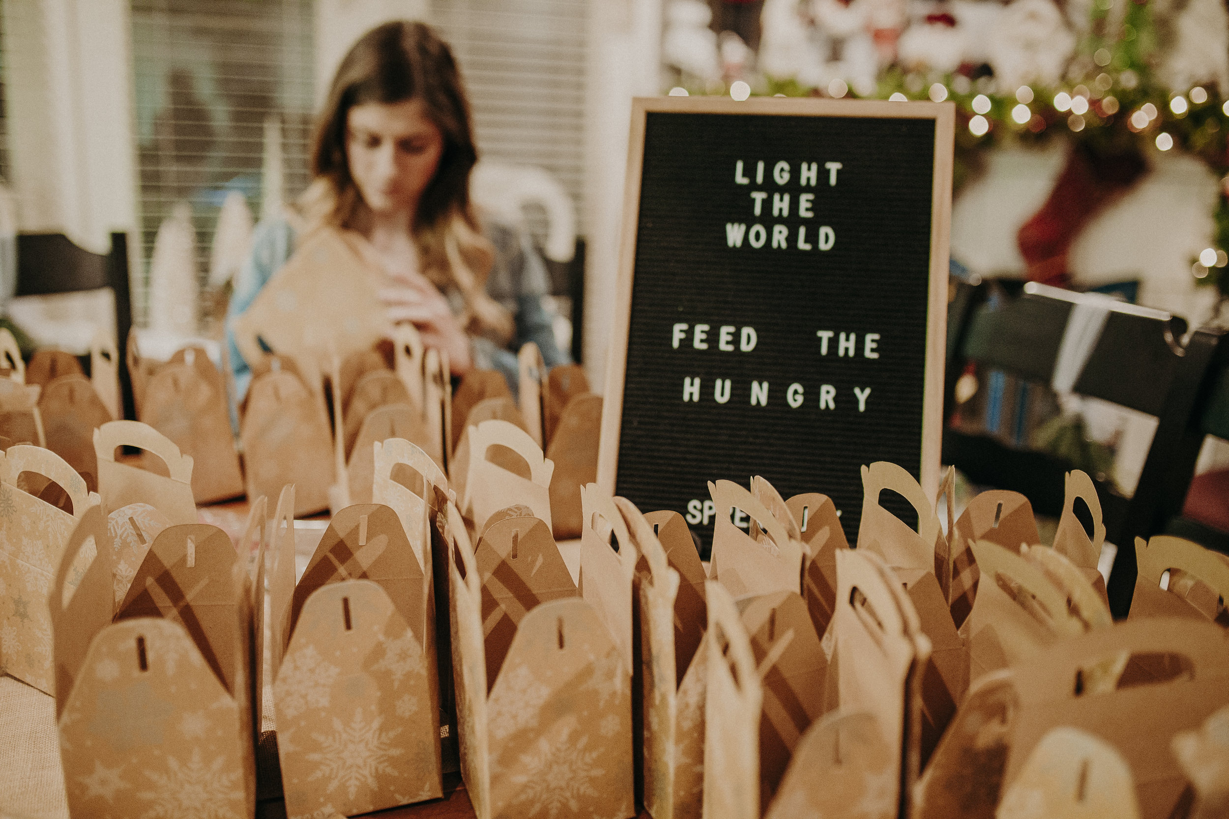  Once my friends came over to help, it was time to put everything together. First up were the lunch boxes. Rather than donating unopened boxes or cans of food, I wanted to create something special. So I picked up these fun lunch boxes, that were easi