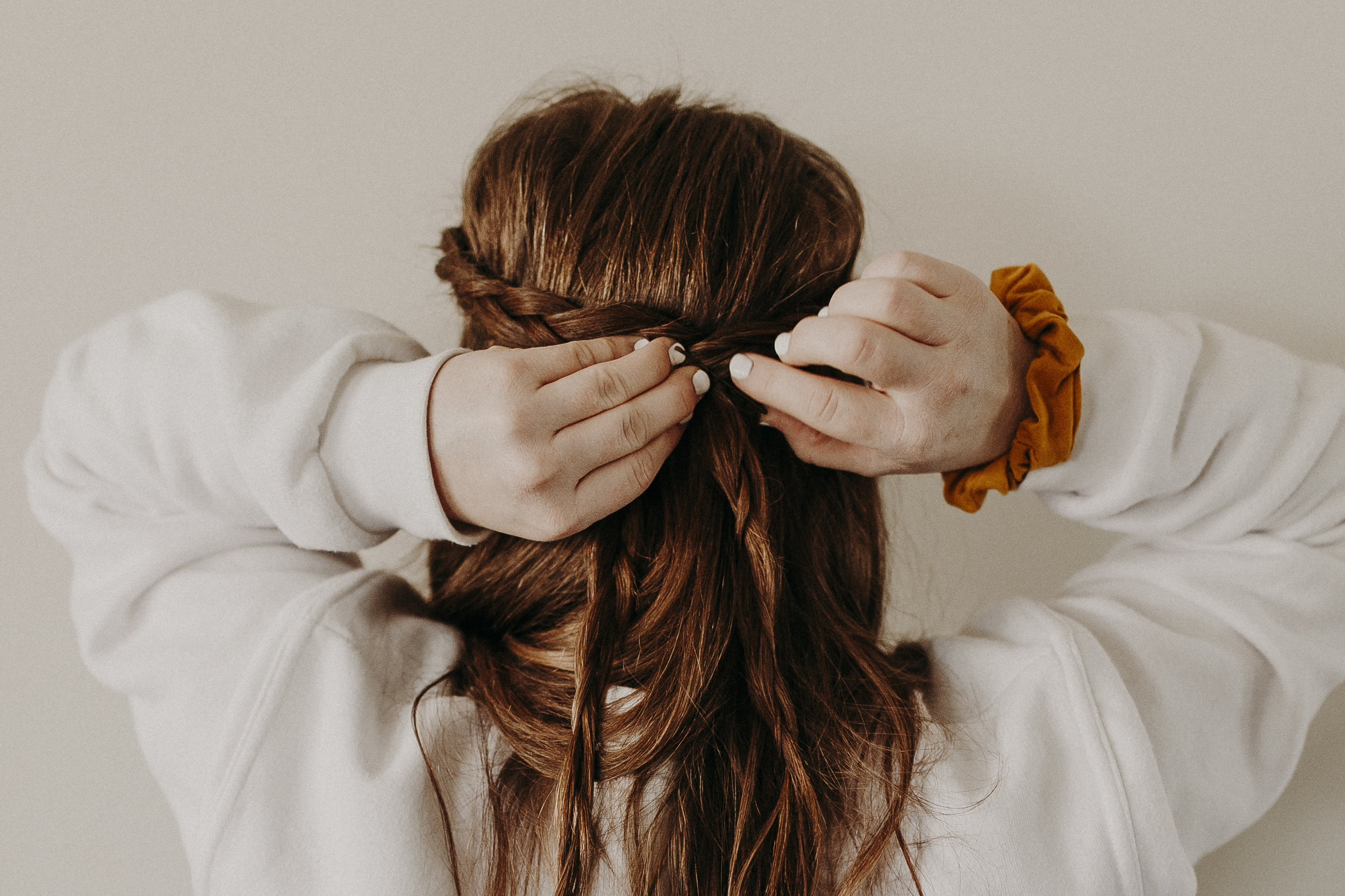  Lastly, is my go-to travel hairdo—the half-up crown braid. This style is so easy to do, looks great with frizzy, curly, or straight hair, and stays in place all day long!     To create this look, I simply start a dutch braid on each side of my part,