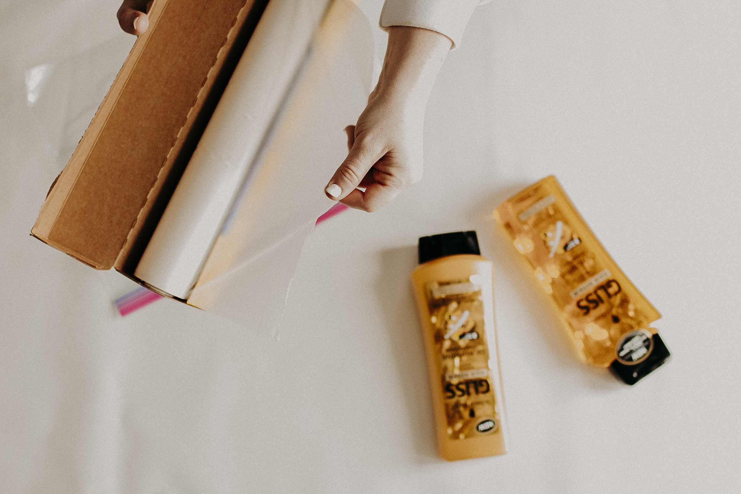  My second tip is how to properly pack your haircare products. There's almost nothing worse than starting a trip, only to realize your shampoo has exploded during flight. You can easily prevent that from happening by applying some plastic food wrap o